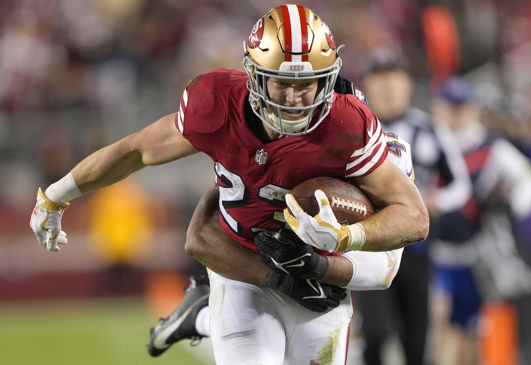 SANTA CLARA, CALIFORNIA - DECEMBER 25: Christian McCaffrey #23 of the San Francisco 49ers carries the ball against the Baltimore Ravens during the second quarter of an NFL football game  at Levi's Stadium on December 25, 2023 in Santa Clara, California. (Photo by Thearon W. Henderson/Getty Images)