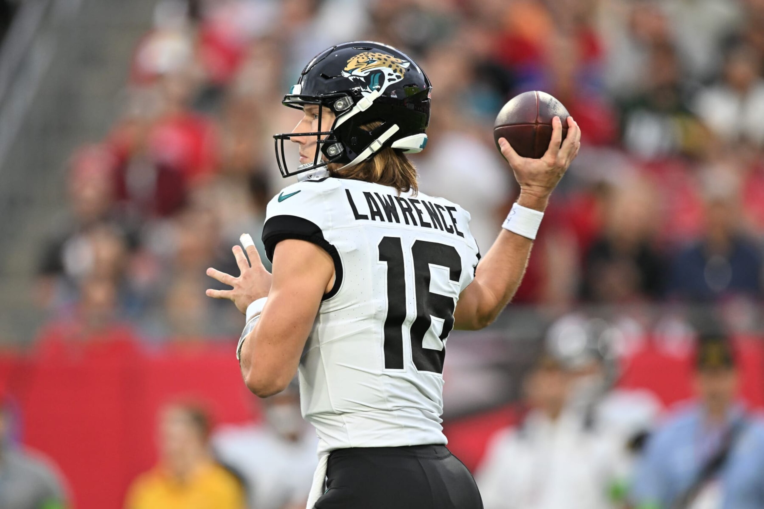 TAMPA, FLORIDA - DECEMBER 24:  Trevor Lawrence #16 of the Jacksonville Jaguars attempts a pass against the Tampa Bay Buccaneers during the second quarter at Raymond James Stadium on December 24, 2023 in Tampa, Florida. (Photo by Julio Aguilar/Getty Images)