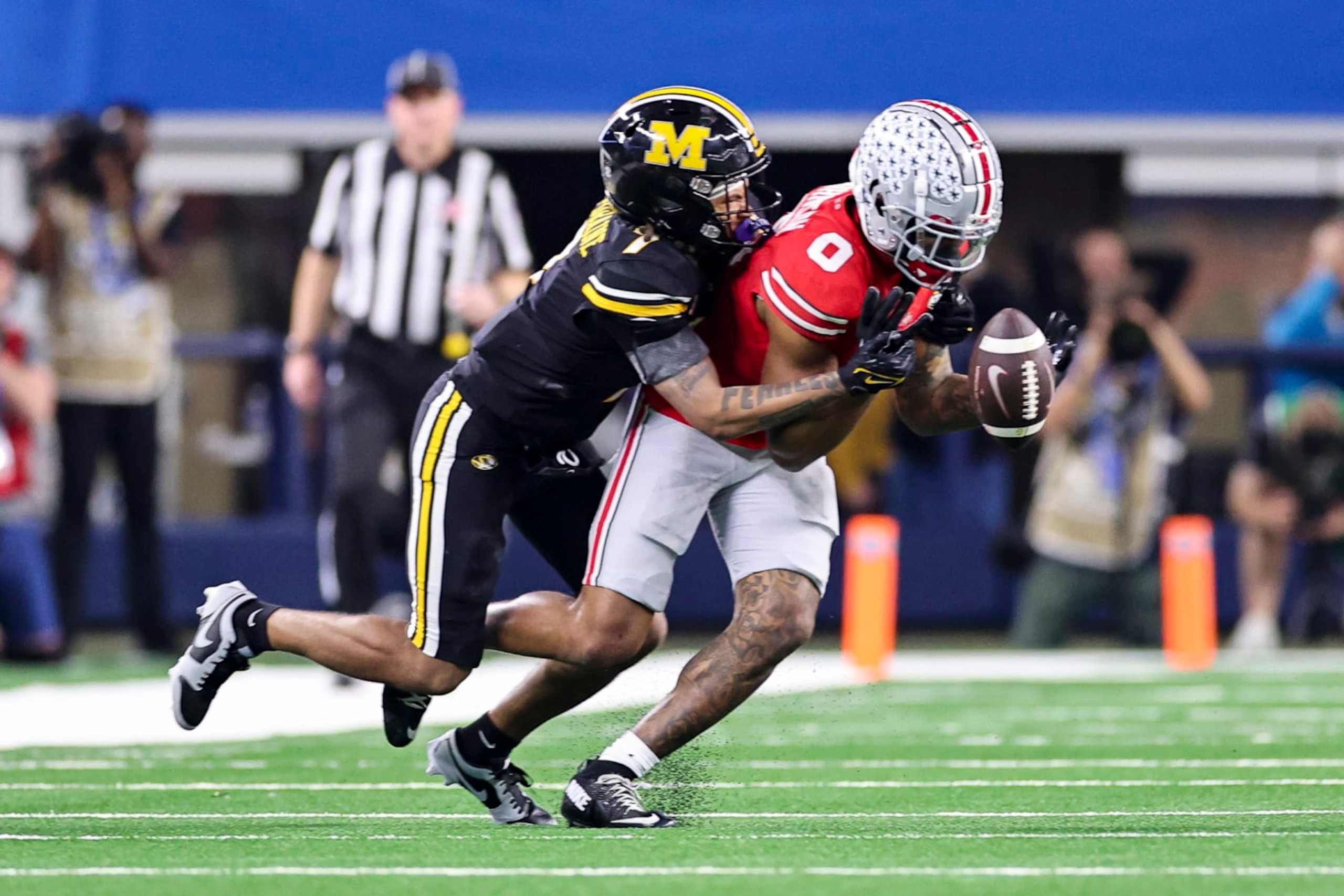 ARLINGTON, TX - DECEMBER 29: Missouri Tigers defensive back Jaylon Carlies (1) knocks the football away from Ohio State Buckeyes wide receiver Xavier Johnson (0) during the 88th Goodyear Cotton Bowl Classic between the Ohio State Buckeyes and the Missouri Tigers on December 29, 2023 at AT&T Stadium in Arlington, Texas. (Photo by Matthew Pearce/Icon Sportswire via Getty Images) ARLINGTON, TX - DECEMBER 29: Missouri Tigers defensive back Jaylon Carlies (1) knocks the football away from Ohio State Buckeyes wide receiver Xavier Johnson (0) during the 88th Goodyear Cotton Bowl Classic between the Ohio State Buckeyes and the Missouri Tigers on December 29, 2023 at AT&T Stadium in Arlington, Texas. (Photo by Matthew Pearce/Icon Sportswire via Getty Images)