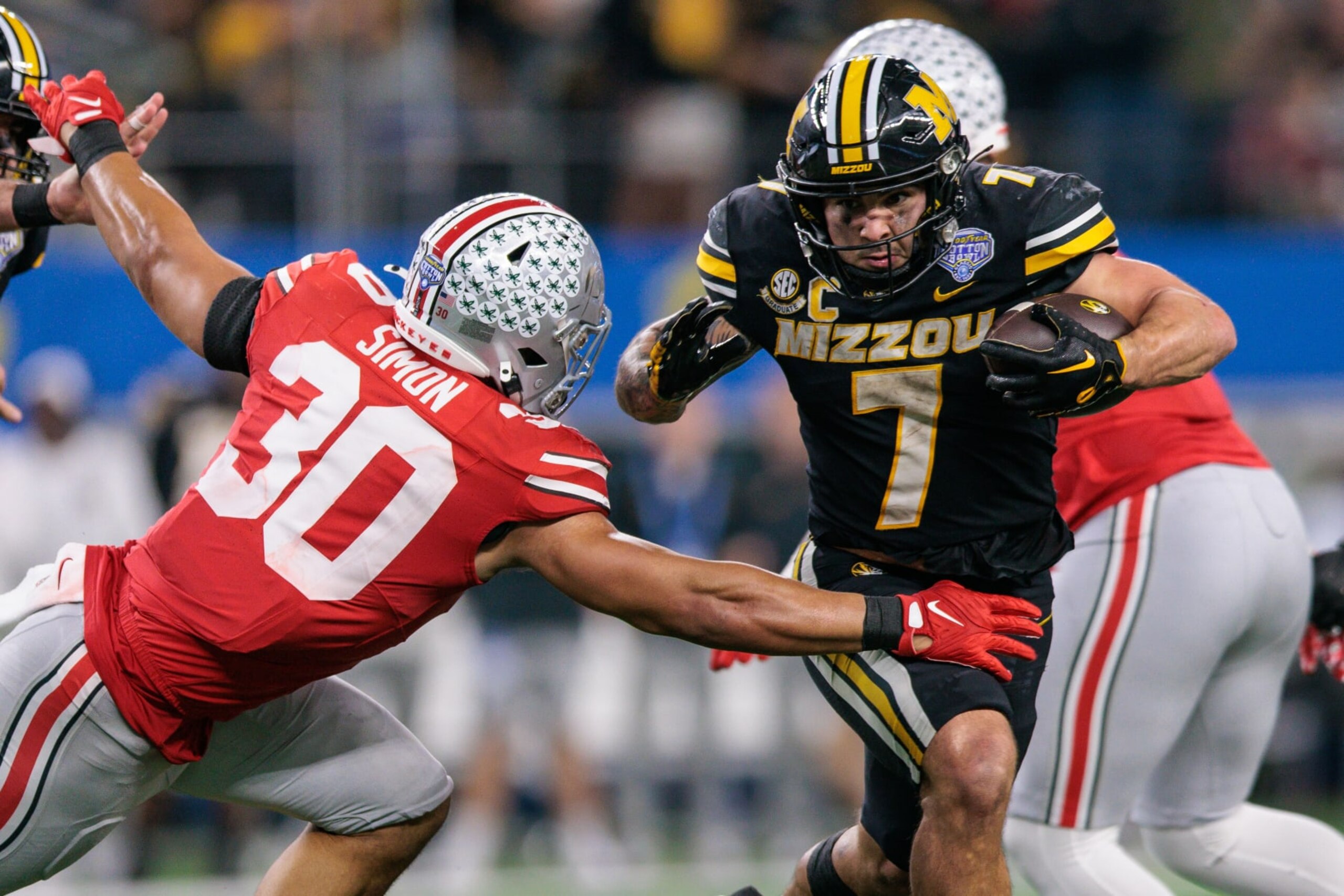 ARLINGTON, TX - DECEMBER 29: Missouri Tigers running back Cody Schrader (7) looks to get past Ohio State Buckeyes linebacker Cody Simon (30) during the 88th Goodyear Cotton Bowl on December 29th, 2023 at ATT Stadium in Arlington Texas. (Photo by William Purnell/Icon Sportswire via Getty Images) ARLINGTON, TX - DECEMBER 29: Missouri Tigers running back Cody Schrader (7) looks to get past Ohio State Buckeyes linebacker Cody Simon (30) during the 88th Goodyear Cotton Bowl on December 29th, 2023 at ATT Stadium in Arlington Texas. (Photo by William Purnell/Icon Sportswire via Getty Images)