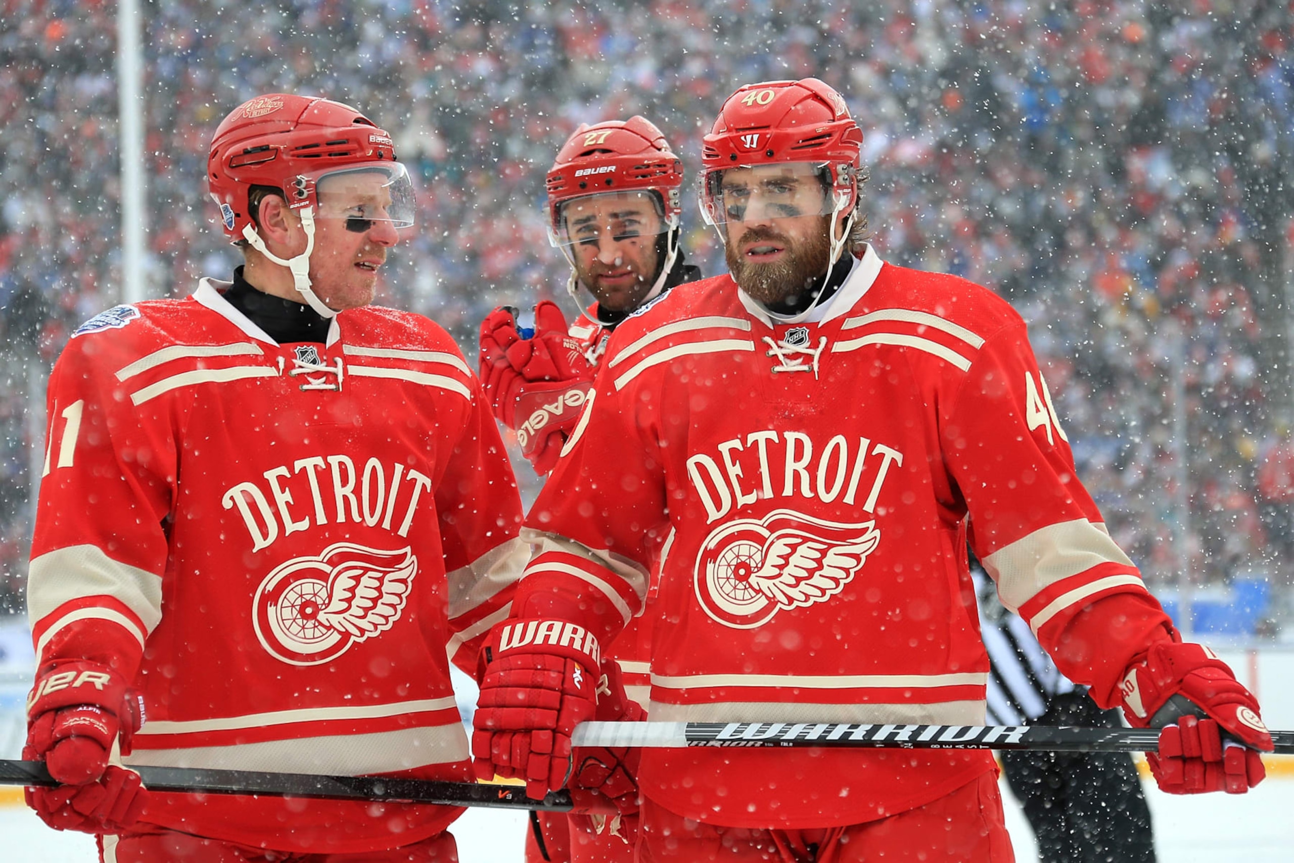 ANN ARBOR, MI - JANUARY 1:  Daniel Alfredsson #11, Kyle Quincey #27 and Henrik Zetterberg #40 of the Detroit Red Wings talk in between whistles during the Bridgestone NHL Winter Classic against the Toronto Maple Leafs on January 1, 2014 at the University of Michigan Stadium in Ann Arbor, Michigan. (Photo by Dave Reginek/NHLI via Getty Images)