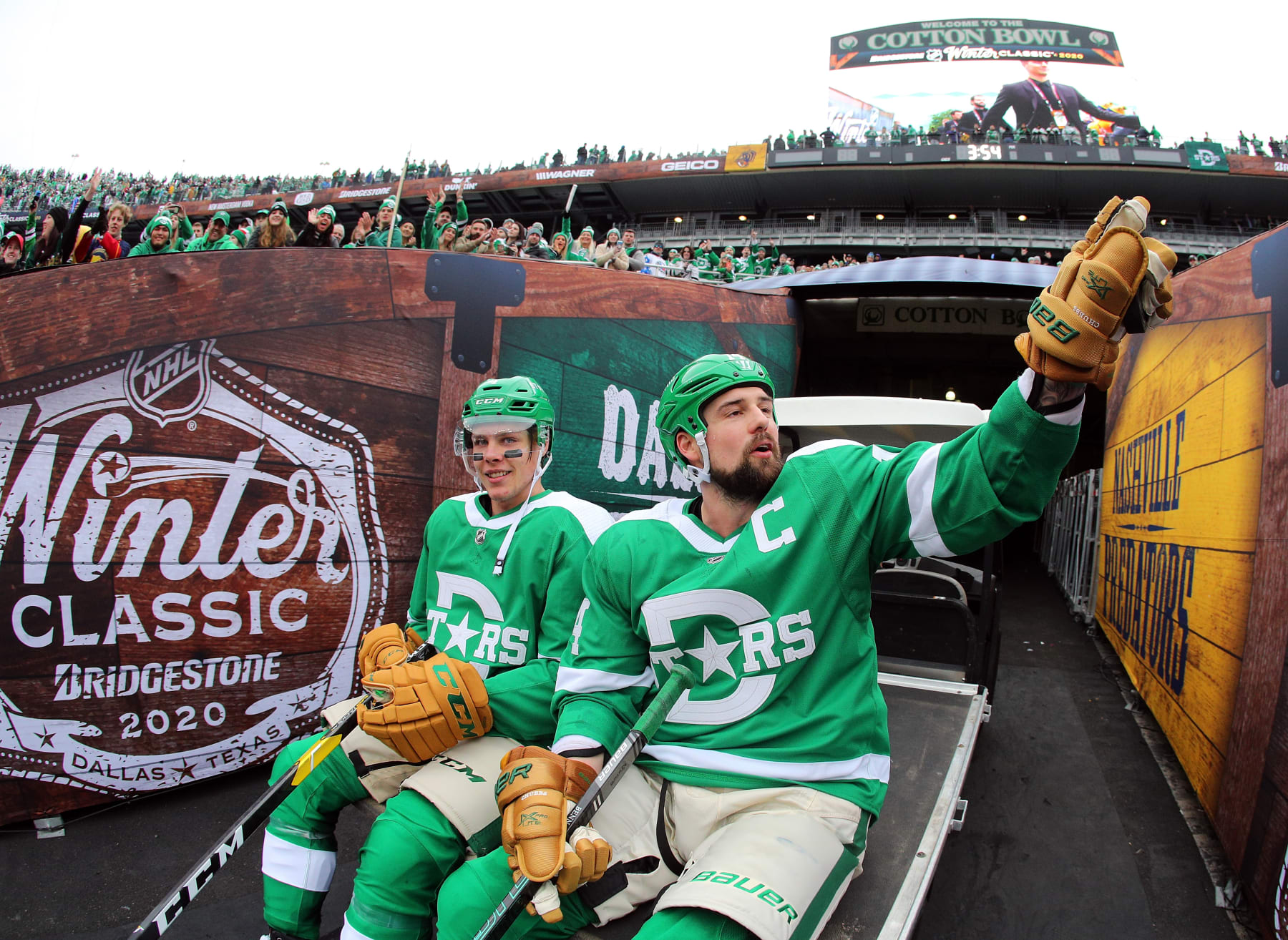 DALLAS, TEXAS - JANUARY 01: Jamie Benn #14 of the Dallas Stars waves to fans as he and teammate Miro Heiskanen #4 ride a cart out of the stadium after the 4-2 over the Nashville Predators in the NHL Winter Classic at the Cotton Bowl on January 01, 2020 in Dallas, Texas. (Photo by Richard Rodriguez/Getty Images)