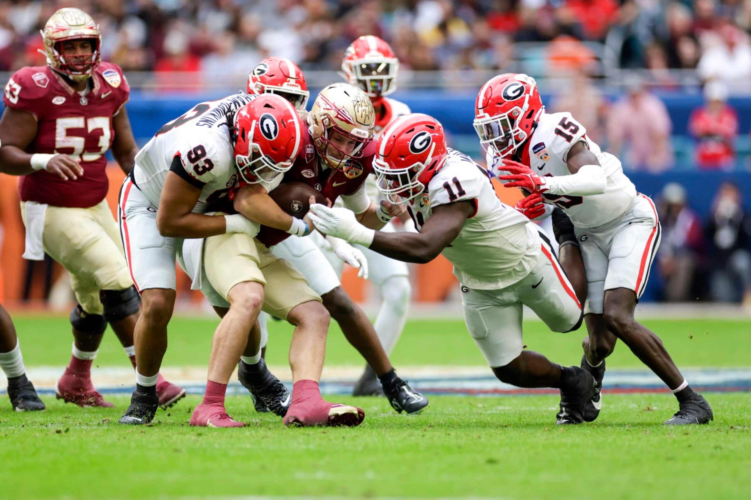 MIAMI GARDENS, FL - DECEMBER 30: Florida State Seminoles quarterback Brock Glenn (11) is tackled by Georgia Bulldogs defensive lineman Tyrion Ingram-Dawkins (93) and Georgia Bulldogs linebacker Jalon Walker (11) during the game between the Georgia Bulldogs and the Florida State Seminoles on December 30, 2023 at Hard Rock Stadium in Miami Gardens, Fl.  (Photo by David Rosenblum/Icon Sportswire via Getty Images)