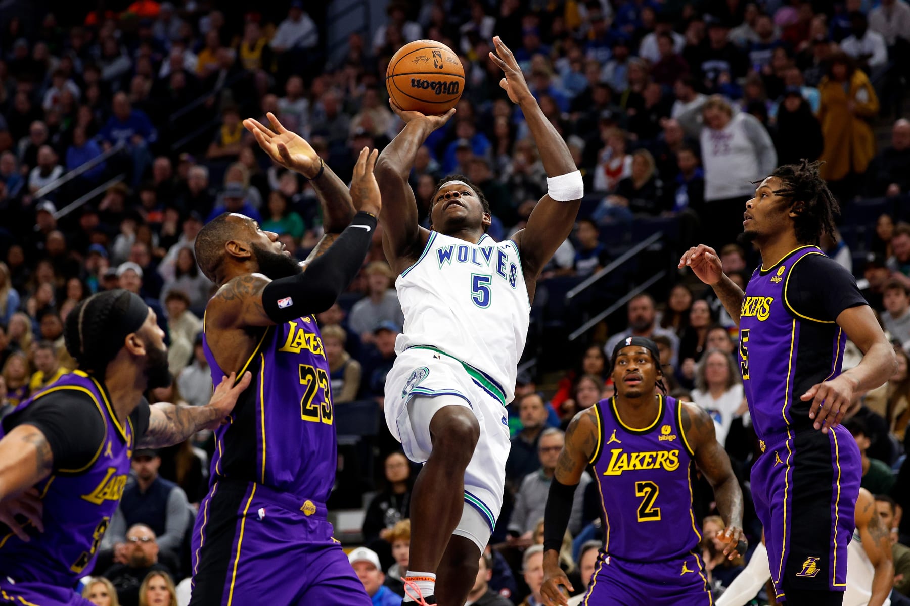 MINNEAPOLIS, MINNESOTA - DECEMBER 30: Anthony Edwards #5 of the Minnesota Timberwolves goes up for a shot while LeBron James #23 of the Los Angeles Lakers defends in the first quarter at Target Center on December 30, 2023 in Minneapolis, Minnesota. NOTE TO USER: User expressly acknowledges and agrees that, by downloading and or using this photograph, User is consenting to the terms and conditions of the Getty Images License Agreement. (Photo by David Berding/Getty Images)