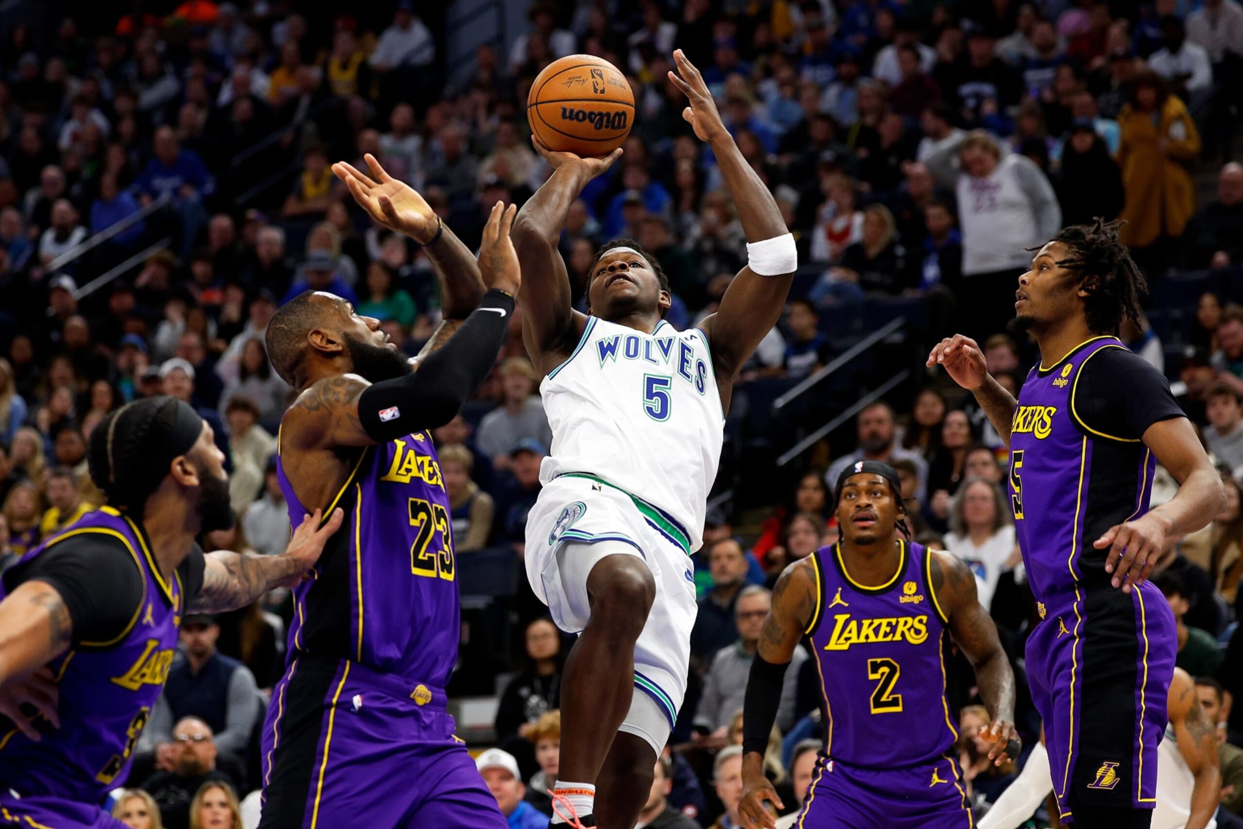 MINNEAPOLIS, MINNESOTA - DECEMBER 30: Anthony Edwards #5 of the Minnesota Timberwolves goes up for a shot while LeBron James #23 of the Los Angeles Lakers defends in the first quarter at Target Center on December 30, 2023 in Minneapolis, Minnesota. NOTE TO USER: User expressly acknowledges and agrees that, by downloading and or using this photograph, User is consenting to the terms and conditions of the Getty Images License Agreement. (Photo by David Berding/Getty Images)