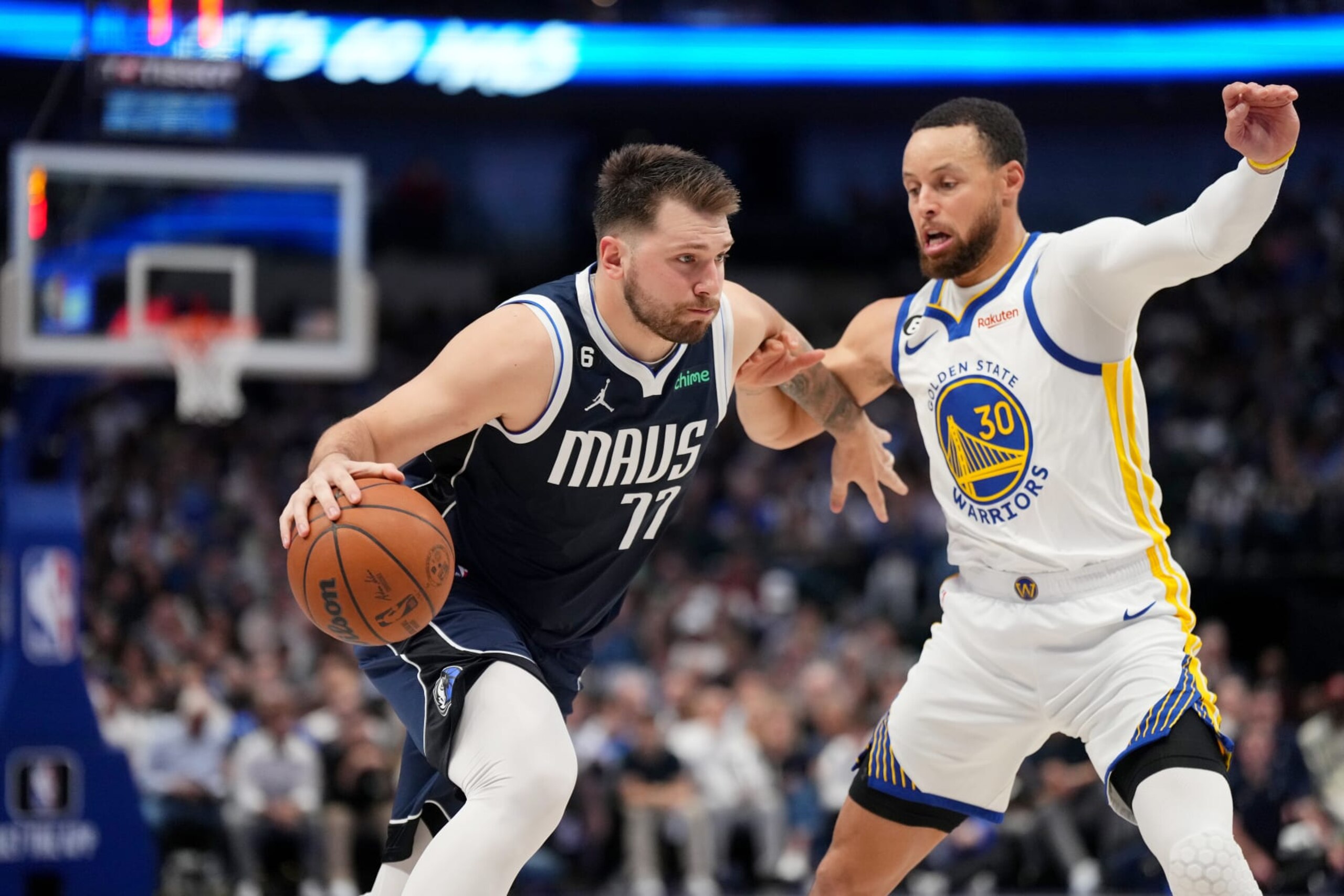 DALLAS, TX - MARCH 22: Luka Doncic #77 of the Dallas Mavericks dribbles the ball against Stephen Curry #30 of the Golden State Warriors on March 22, 2023 at the American Airlines Center in Dallas, Texas. NOTE TO USER: User expressly acknowledges and agrees that, by downloading and or using this photograph, User is consenting to the terms and conditions of the Getty Images License Agreement. Mandatory Copyright Notice: Copyright 2023 NBAE (Photo by Cooper Neill/NBAE via Getty Images)