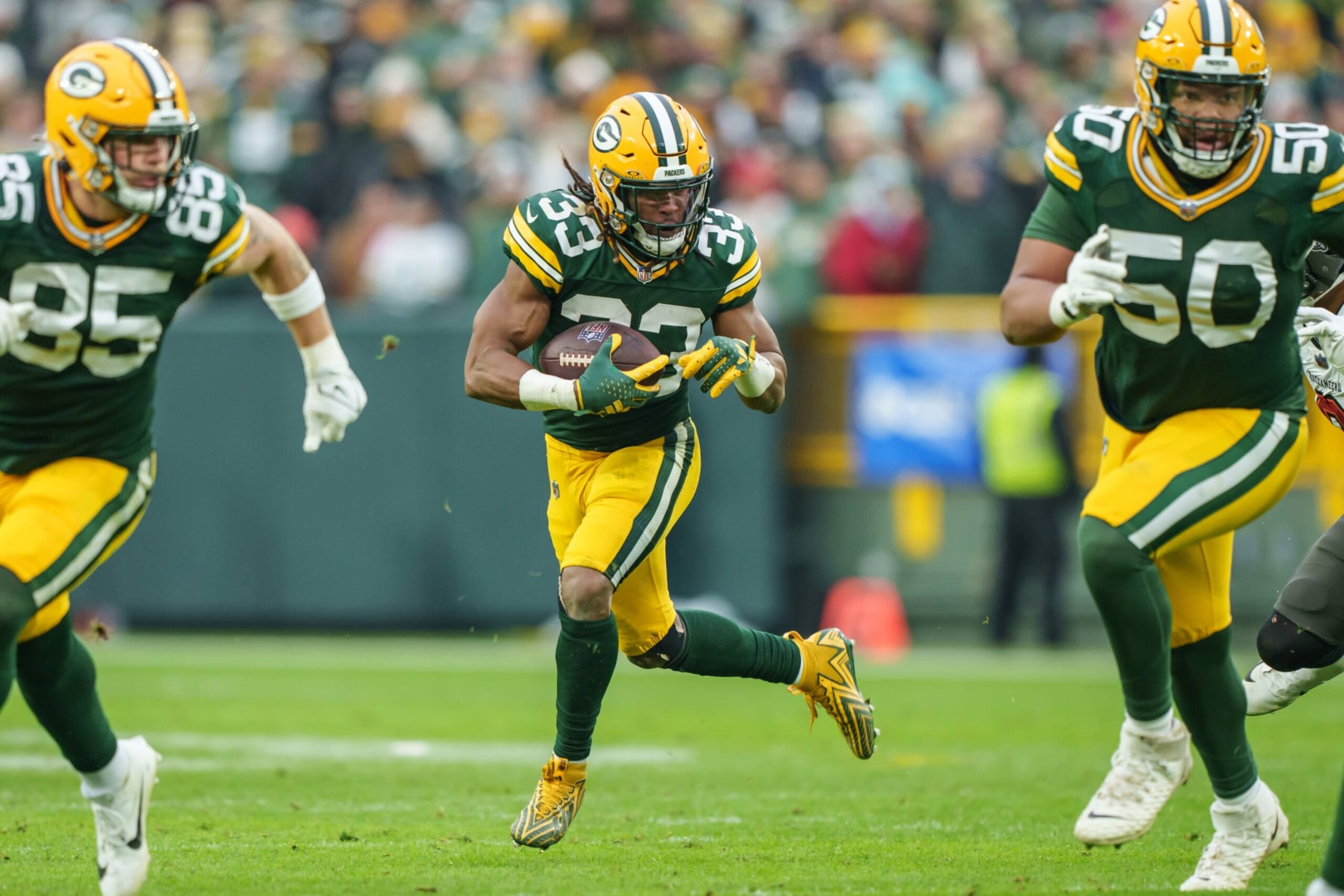 GREEN BAY, WI - DECEMBER 17: Running Back Aaron Jones #33 of the Green Bay Packers runs with the ball during the second half of an NFL football game against the Tampa Bay Buccaneers at Lambeau Field on December 17, 2023 in Green Bay, Wisconsin. The Buccaneers beat the Packers 34-20. (Photo by Todd Rosenberg/Getty Images)
