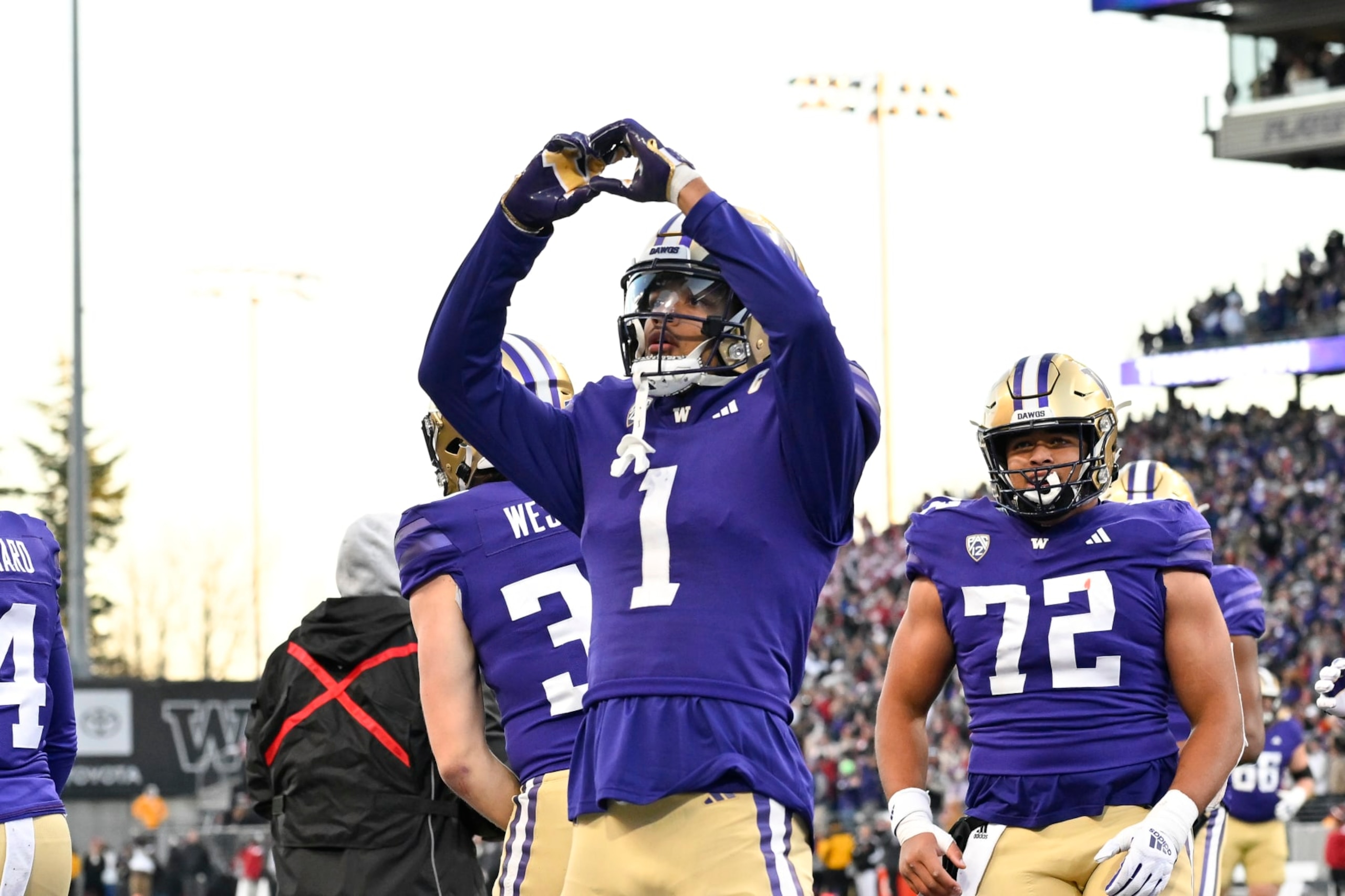 SEATTLE, WASHINGTON - NOVEMBER 25: Rome Odunze #1 of the Washington Huskies reacts after scoring a touchdown againstthe Washington State Cougars during the third quarter at Husky Stadium on November 25, 2023 in Seattle, Washington. The Washington Huskies won 24-21. (Photo by Alika Jenner/Getty Images)