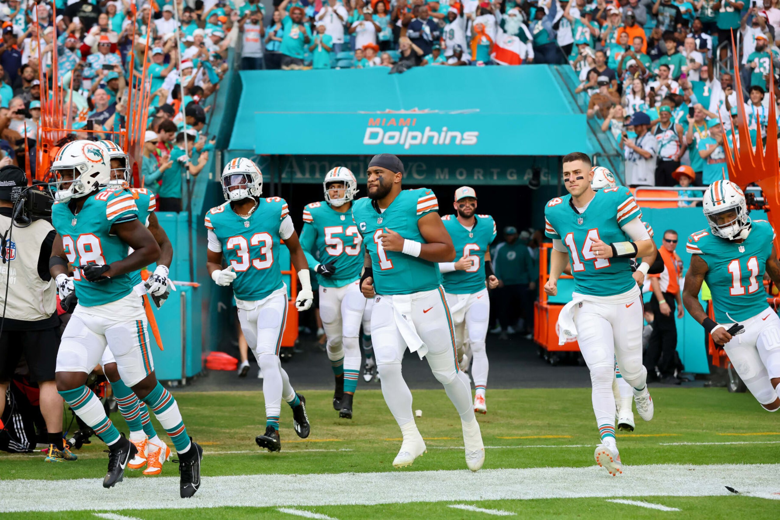 MIAMI GARDENS, FLORIDA - DECEMBER 24: Tua Tagovailoa #1 and the Miami Dolphins takes the field during player introductions prior to the game against the Dallas Cowboys at Hard Rock Stadium on December 24, 2023 in Miami Gardens, Florida. (Photo by Stacy Revere/Getty Images)