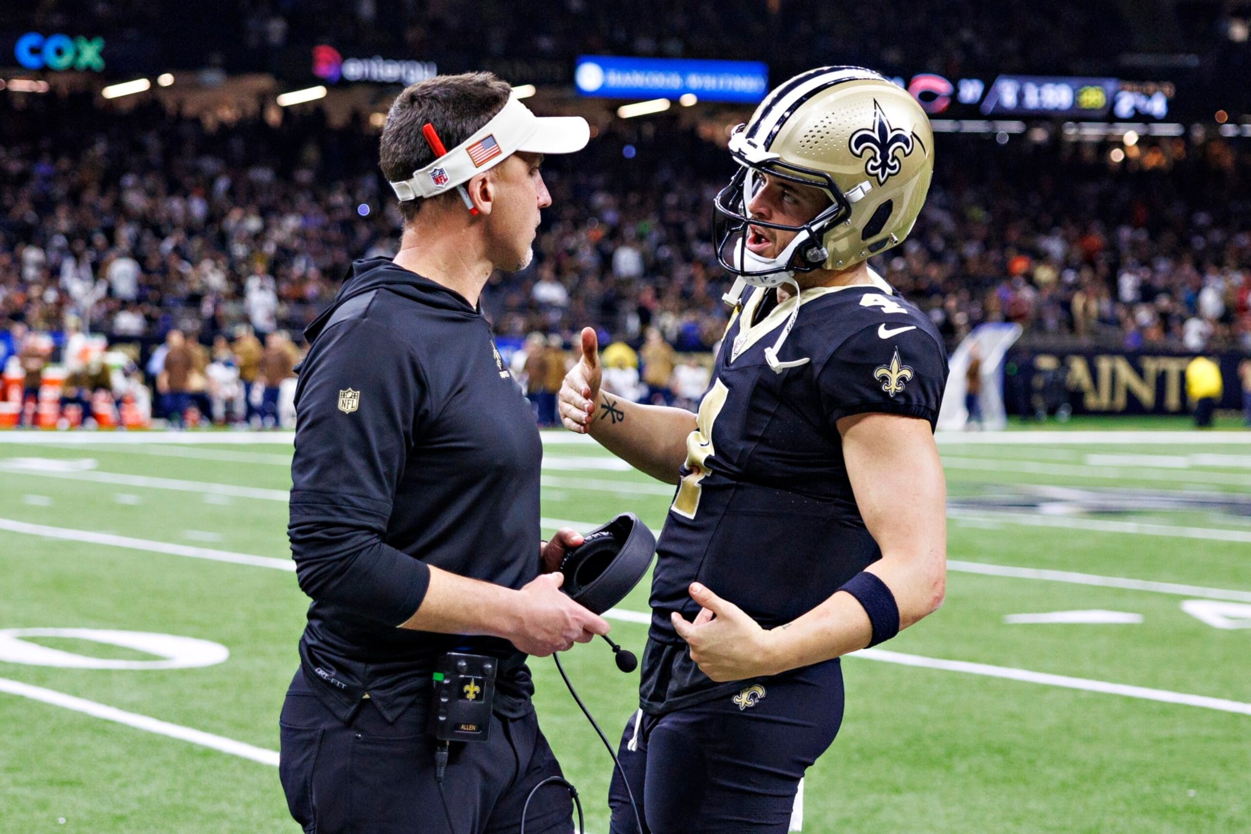 NEW ORLEANS, LOUISIANA - NOVEMBER 05:  Head Coach Dennis Allen talks on the sidelines with Derek Carr #4 of the New Orleans Saints during a game against the Chicago Bears at Caesars Superdome on November 5, 2023 in New Orleans, Louisiana. The Saints defeated the Bears 24-17. (Photo by Wesley Hitt/Getty Images)