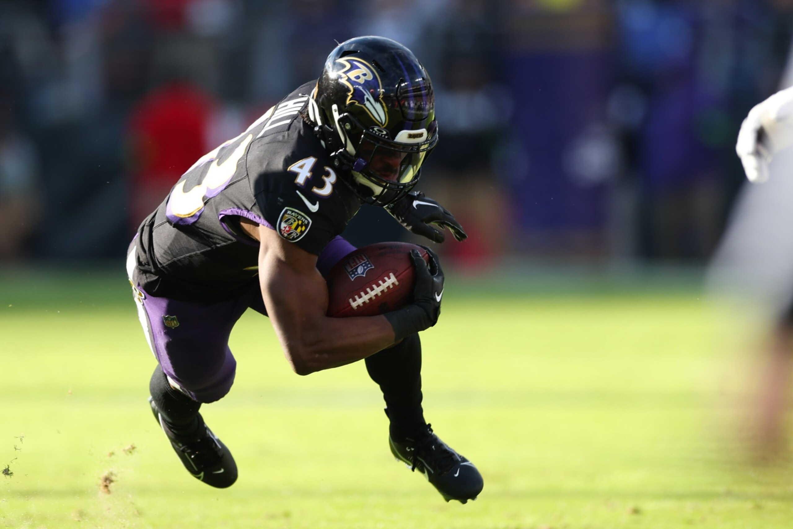 BALTIMORE, MARYLAND - DECEMBER 31: Justice Hill #43 of the Baltimore Ravens carries the ball against the Miami Dolphins during the second quarter of the game at M&T Bank Stadium on December 31, 2023 in Baltimore, Maryland. (Photo by Rob Carr/Getty Images)