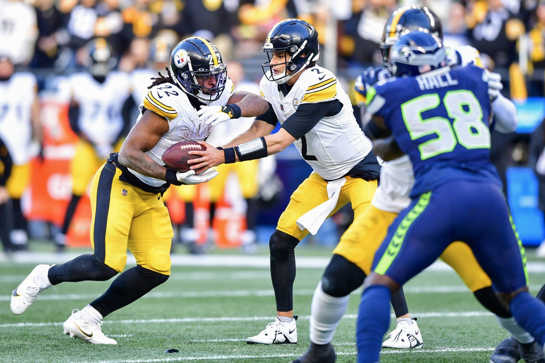 SEATTLE, WASHINGTON - DECEMBER 31: Mason Rudolph #2  hands the ball off to Najee Harris #22 of the Pittsburgh Steelers during the second quarter against the Seattle Seahawks at Lumen Field on December 31, 2023 in Seattle, Washington. (Photo by Jane Gershovich/Getty Images)