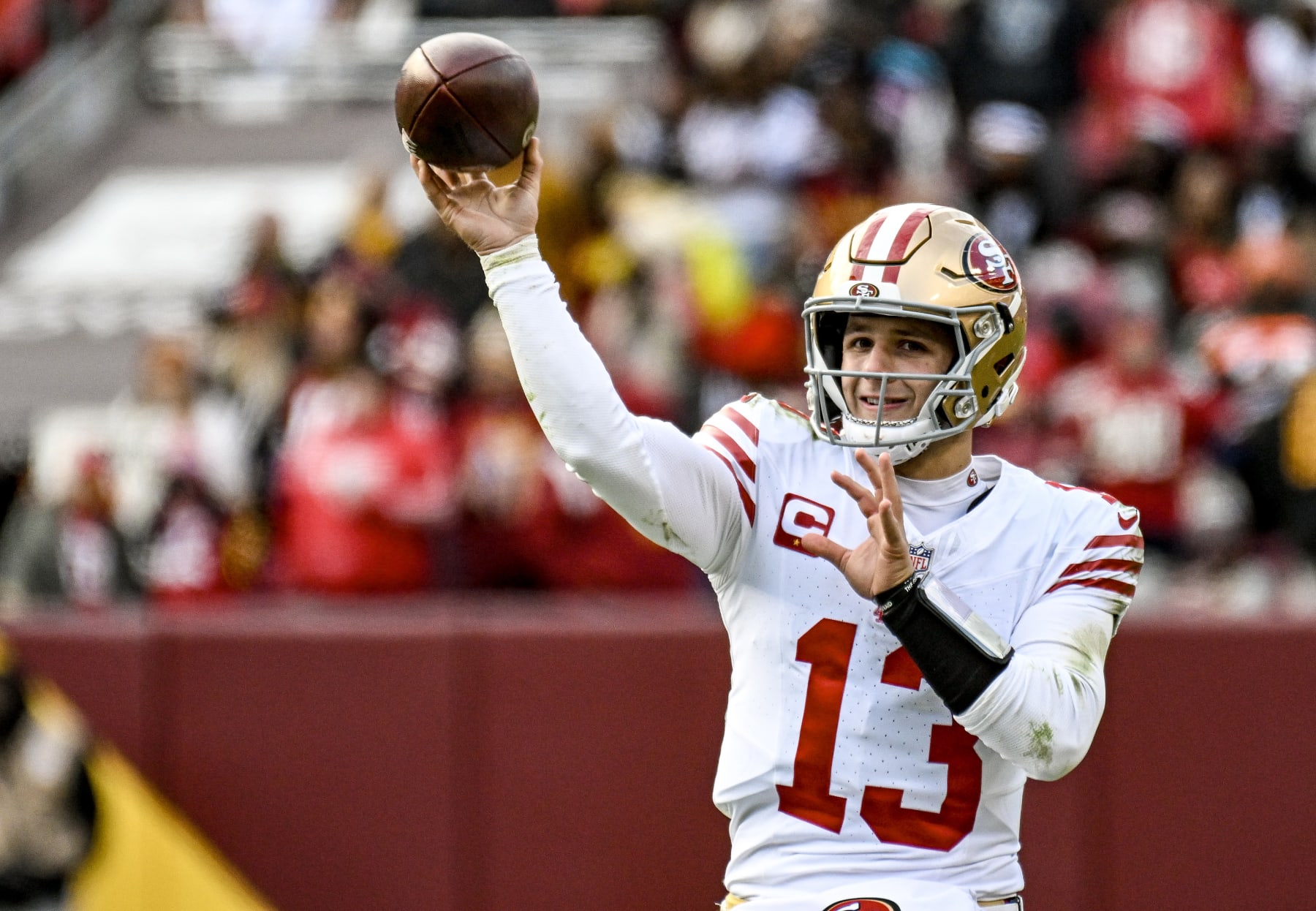 LANDOVER, MD - DECEMBER 31: San Francisco 49ers quarterback Brock Purdy (13) keeps warm on the sidelines during the NFL game between the San Francisco 49ers and the Washington Commanders on December 31, 2023 at Fed Ex Field in Landover, MD. (Photo by Mark Goldman/Icon Sportswire via Getty Images)