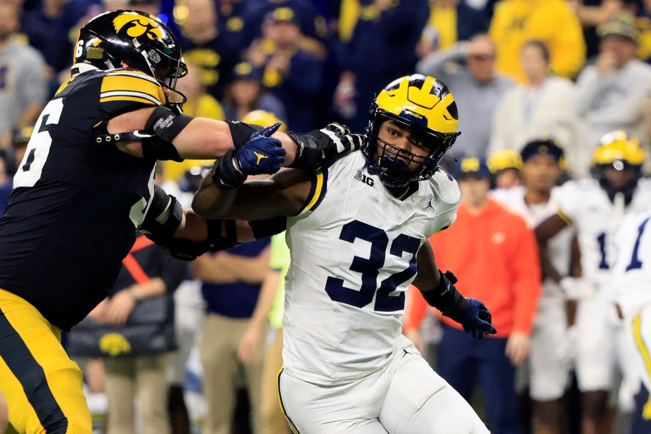 INDIANAPOLIS, INDIANA - DECEMBER 02: Jaylen Harrell #32 of the Michigan Wolverines makes a move on Nick DeJong #56 of the Iowa Hawkeyes during the Big Ten Championship at Lucas Oil Stadium on December 02, 2023 in Indianapolis, Indiana. (Photo by Justin Casterline/Getty Images)