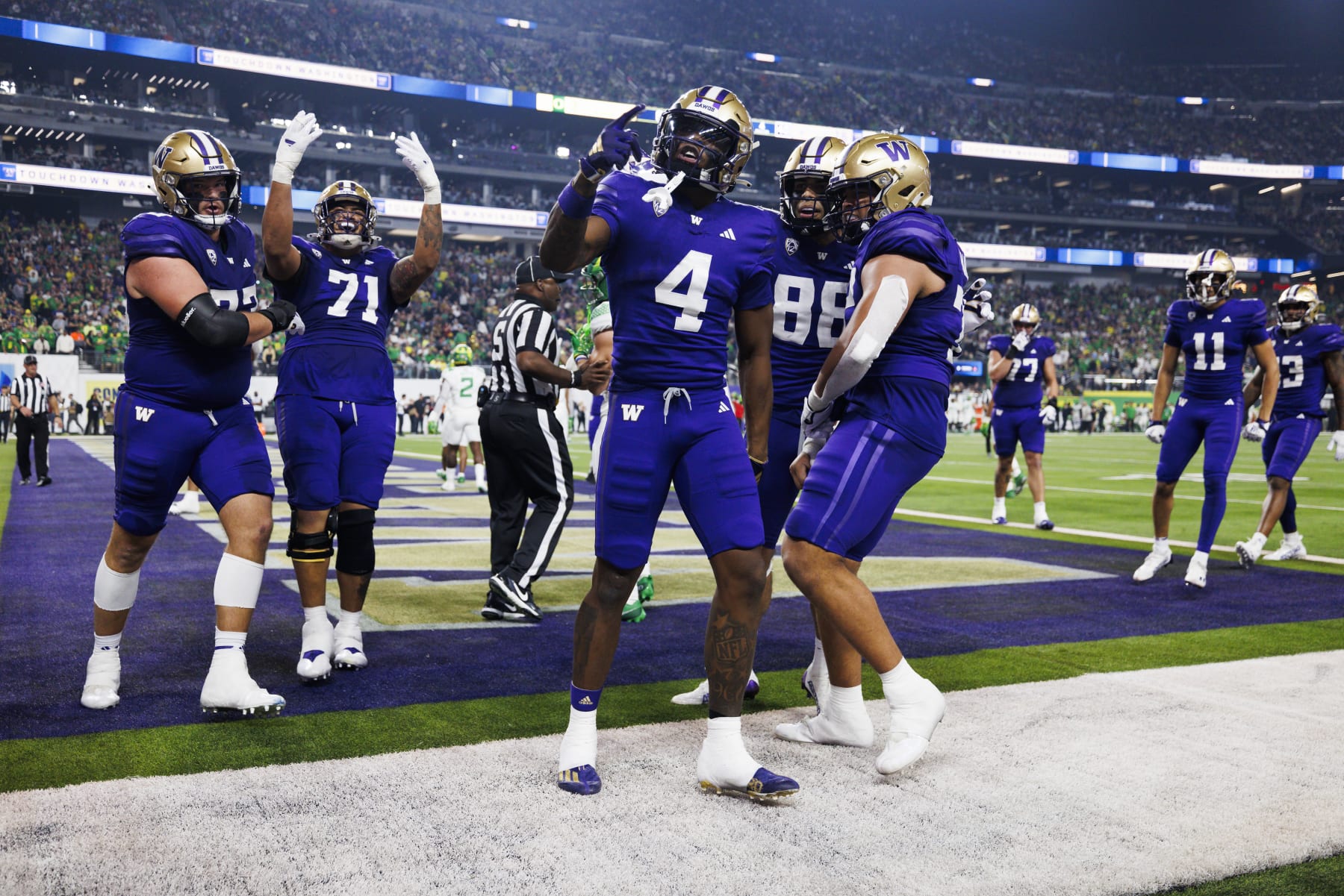 LAS VEGAS, NEVADA - DECEMBER 1: Germie Bernard #4 of the Washington Huskies celebrates with teammates against the Oregon Ducks during the Pac-12 Championship at Allegiant Stadium on December 1, 2023 in Las Vegas, Nevada. (Photo by Ric Tapia/Getty Images)