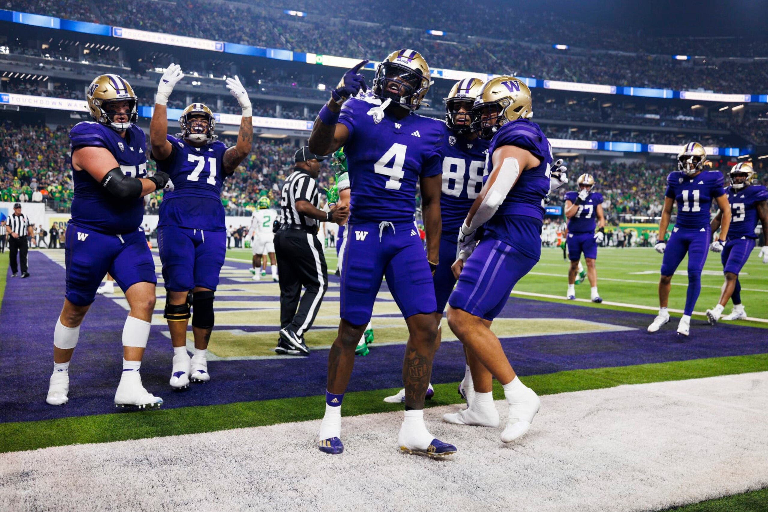 LAS VEGAS, NEVADA - DECEMBER 1: Germie Bernard #4 of the Washington Huskies celebrates with teammates against the Oregon Ducks during the Pac-12 Championship at Allegiant Stadium on December 1, 2023 in Las Vegas, Nevada. (Photo by Ric Tapia/Getty Images)