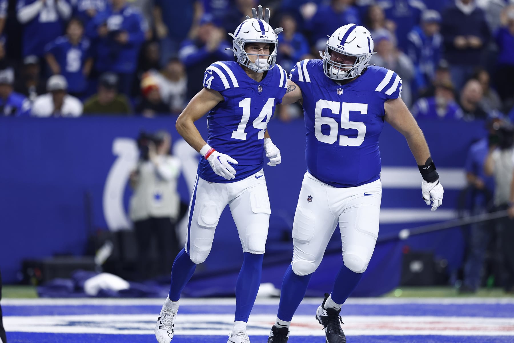 INDIANAPOLIS, IN - DECEMBER 31: Indianapolis Colts guard Josh Sills (65) congratulates Indianapolis Colts wide receiver Alec Pierce (14) on his touchdown during a NFL game between the Las Vegas Raiders and the Indianapolis Colts on December 31, 2023 at Lucas Oil Stadium in Indianapolis, IN.  (Photo by Jeffrey Brown/Icon Sportswire via Getty Images)