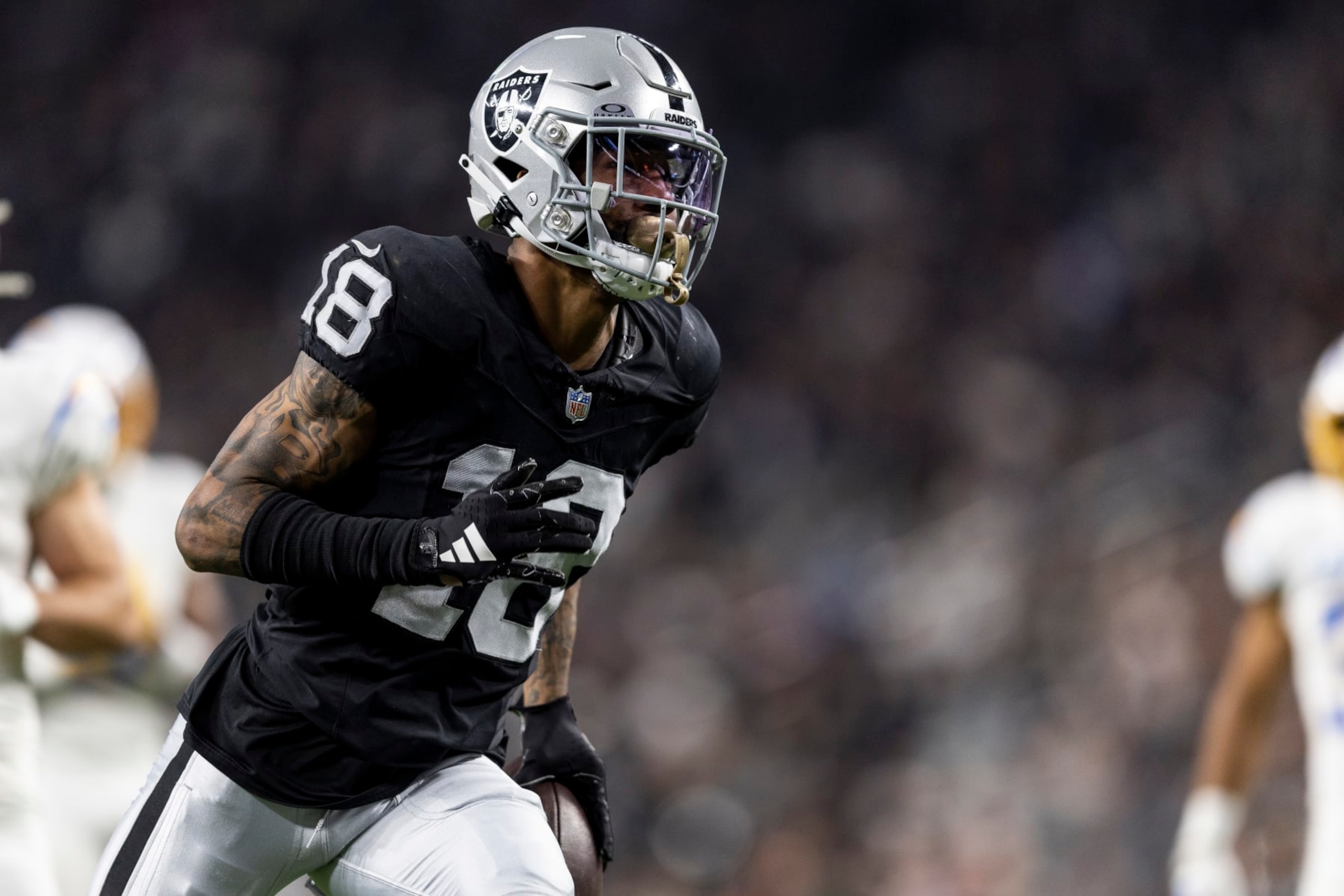 LAS VEGAS, NEVADA - DECEMBER 14: Jack Jones #18 of the Las Vegas Raiders runs for a touchdown after intercepting a pass during an NFL football game between the Las Vegas Raiders and the Los Angeles Chargers at Allegiant Stadium on December 14, 2023 in Las Vegas, Nevada. (Photo by Michael Owens/Getty Images) LAS VEGAS, NEVADA - DECEMBER 14: Jack Jones #18 of the Las Vegas Raiders runs for a touchdown after intercepting a pass during an NFL football game between the Las Vegas Raiders and the Los Angeles Chargers at Allegiant Stadium on December 14, 2023 in Las Vegas, Nevada. (Photo by Michael Owens/Getty Images)