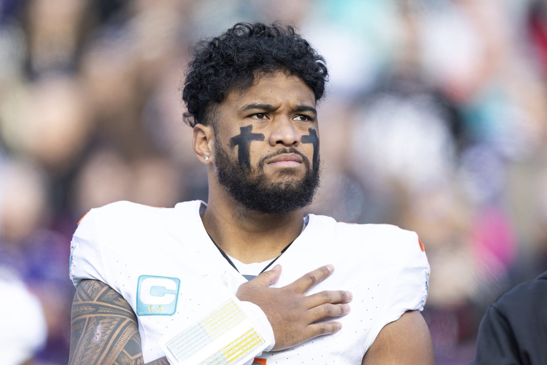 BALTIMORE, MARYLAND - DECEMBER 31: Tua Tagovailoa #1 of the Miami Dolphins looks on during the national anthem prior to an NFL football game between the Baltimore Ravens and the Miami Dolphins at M&T Bank Stadium on December 31, 2023 in Baltimore, Maryland. (Photo by Michael Owens/Getty Images)