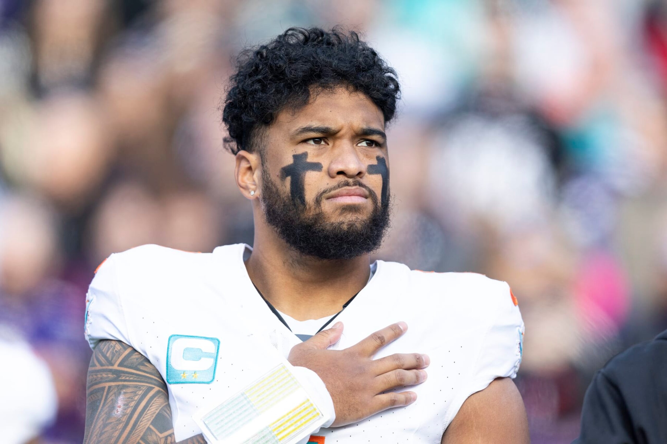 BALTIMORE, MARYLAND - DECEMBER 31: Tua Tagovailoa #1 of the Miami Dolphins looks on during the national anthem prior to an NFL football game between the Baltimore Ravens and the Miami Dolphins at M&T Bank Stadium on December 31, 2023 in Baltimore, Maryland. (Photo by Michael Owens/Getty Images)