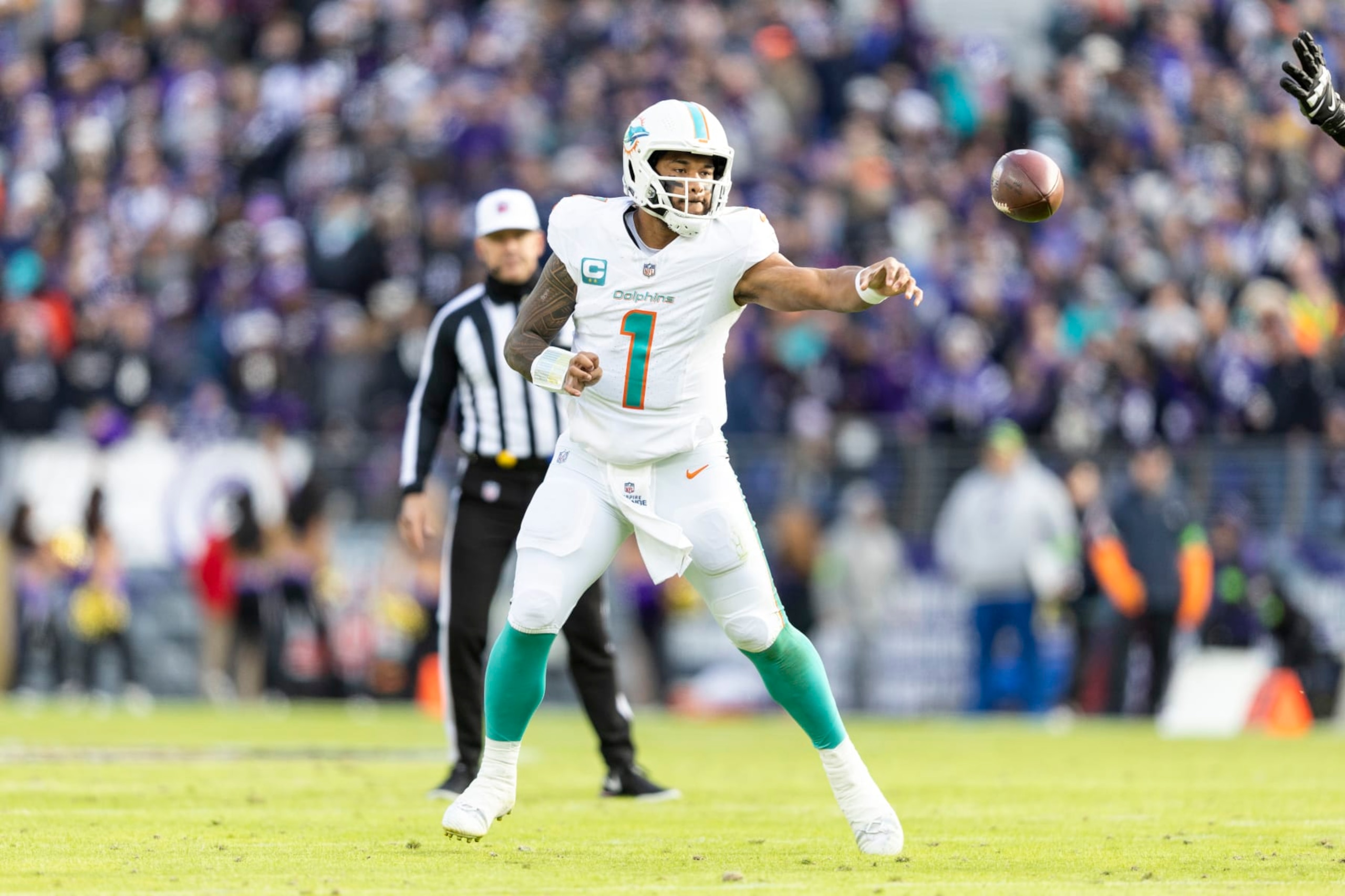 BALTIMORE, MARYLAND - DECEMBER 31: Tua Tagovailoa #1 of the Miami Dolphins throws a pass during an NFL football game between the Baltimore Ravens and the Miami Dolphins at M&T Bank Stadium on December 31, 2023 in Baltimore, Maryland. (Photo by Michael Owens/Getty Images)