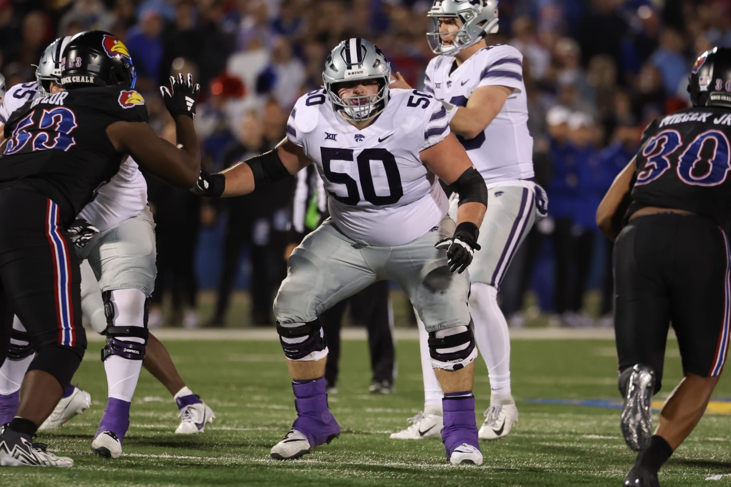 LAWRENCE, KS - NOVEMBER 18: Kansas State Wildcats offensive lineman Cooper Beebe (50) looks to block in the fourth quarter of a Big 12 football game between the Kansas State Wildcats and Kansas Jayhawks on Nov 18, 2023 at Memorial Stadium in Lawrence, KS. (Photo by Scott Winters/Icon Sportswire via Getty Images) LAWRENCE, KS - NOVEMBER 18: Kansas State Wildcats offensive lineman Cooper Beebe (50) looks to block in the fourth quarter of a Big 12 football game between the Kansas State Wildcats and Kansas Jayhawks on Nov 18, 2023 at Memorial Stadium in Lawrence, KS. (Photo by Scott Winters/Icon Sportswire via Getty Images)