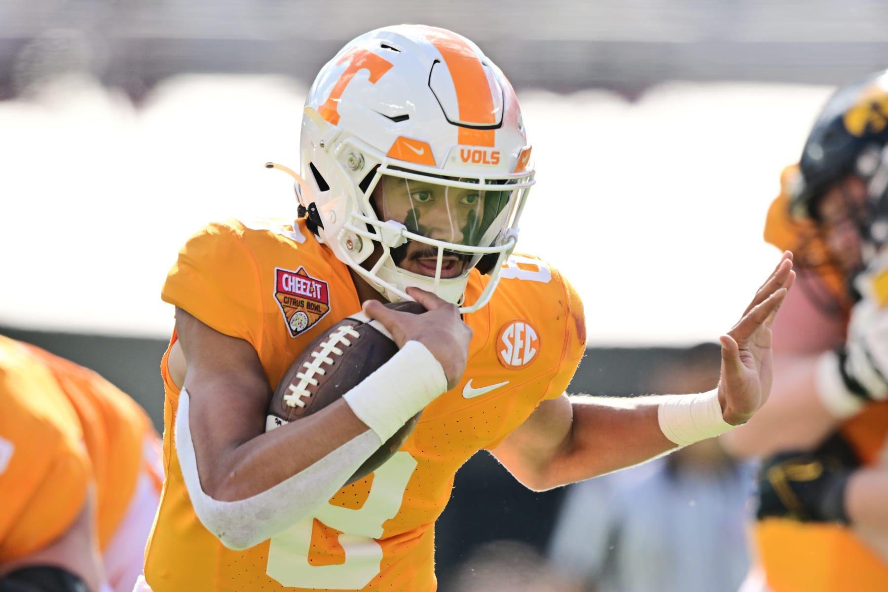 ORLANDO, FLORIDA - JANUARY 01: Nico Iamaleava #8 of the Tennessee Volunteers rushes for a 19-yard touchdown in the second quarter against the Iowa Hawkeyes during the 2024 Cheez-It Citrus Bowl at Camping World Stadium on January 01, 2024 in Orlando, Florida. (Photo by Julio Aguilar/Getty Images)