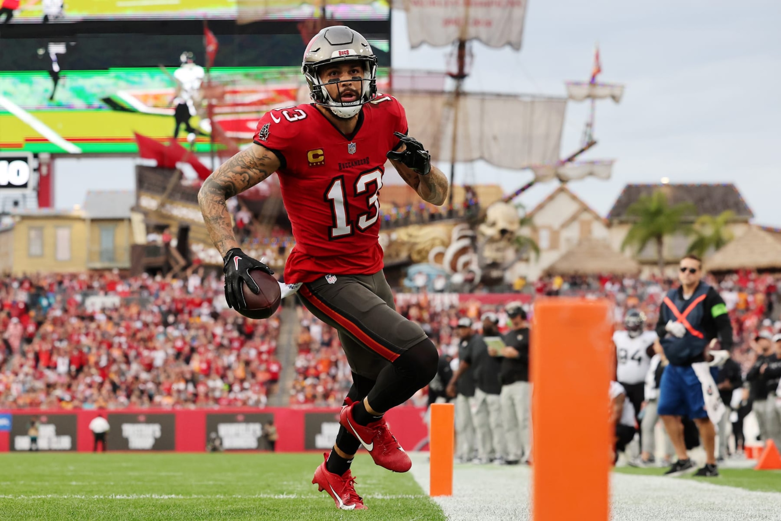 TAMPA, FLORIDA - DECEMBER 24:  Mike Evans #13 of the Tampa Bay Buccaneers scores a touchdown reception against the Jacksonville Jaguars during the second quarter at Raymond James Stadium on December 24, 2023 in Tampa, Florida. (Photo by Mike Carlson/Getty Images)
