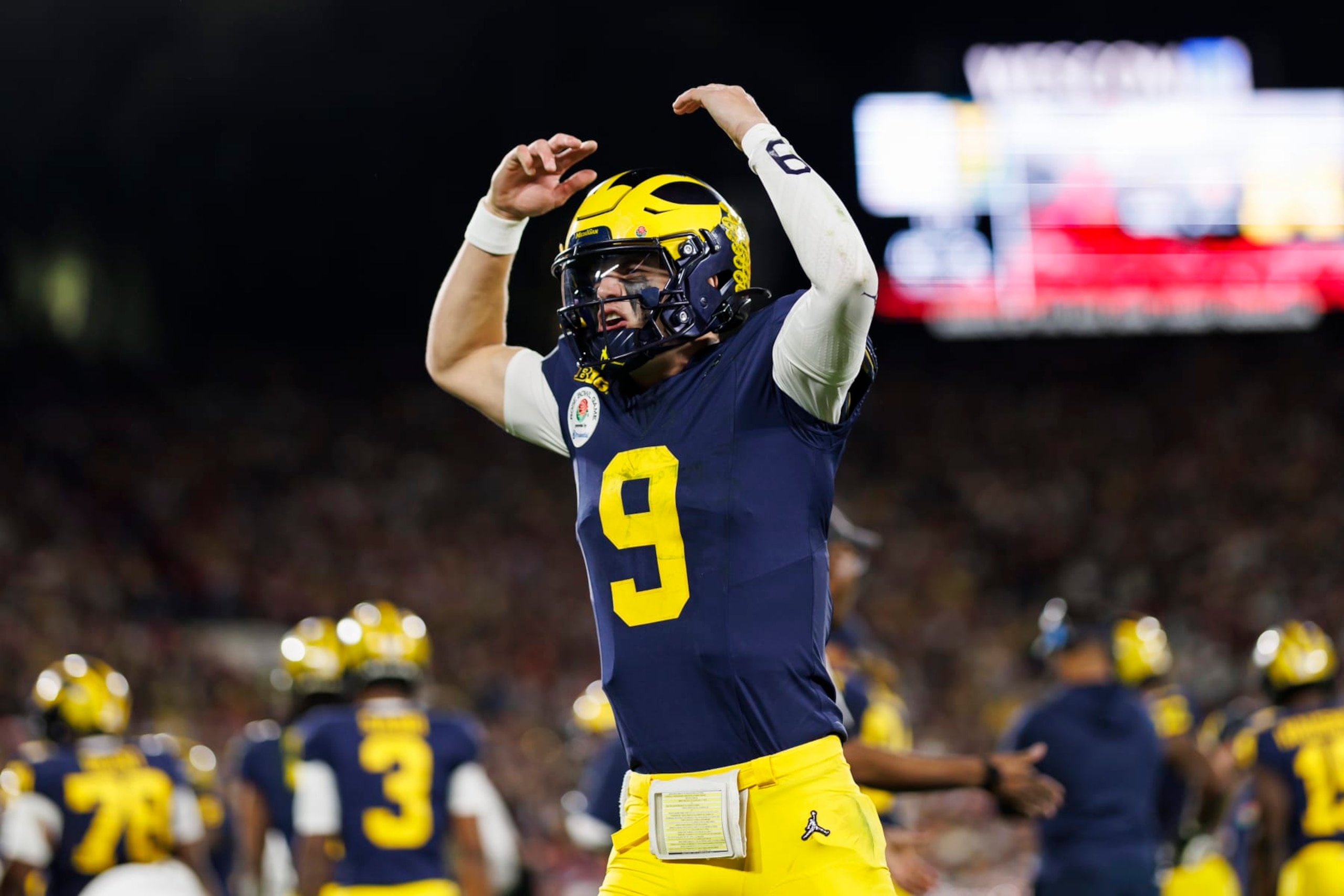 PASADENA, CALIFORNIA - JANUARY 01: Quarterback J.J. McCarthy #9 of the Michigan Wolverines celebrates on the sideline in overtime during the CFP Semifinal Rose Bowl Game against the Alabama Crimson Tide at Rose Bowl Stadium on January 1, 2024 in Pasadena, California. (Photo by Ryan Kang/Getty Images)