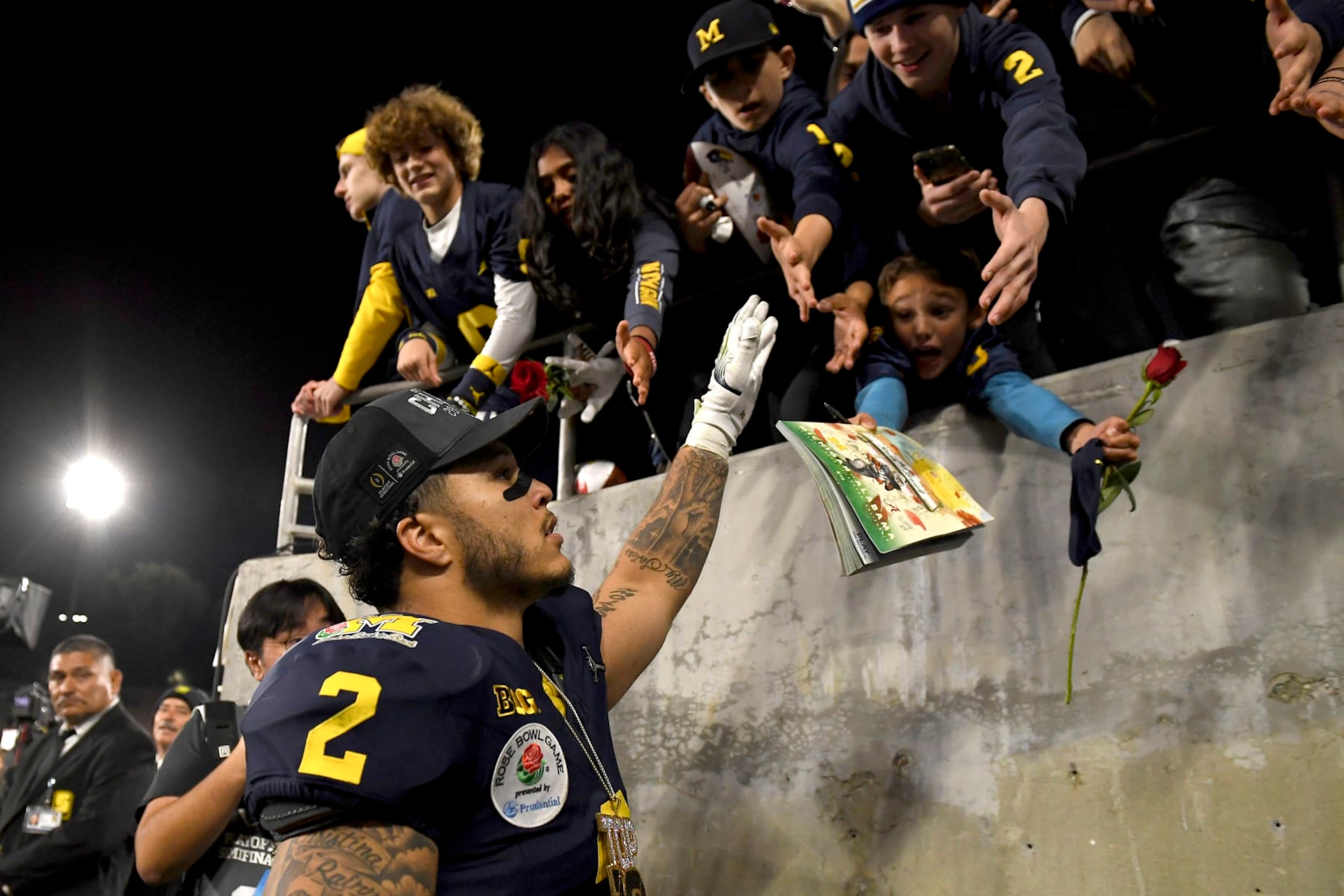 Michigan running back Blake Corum (2) greats fans as he walks off the field after defeating Alabama during overtime at the Rose Bowl CFP NCAA semifinal college football game Monday, Jan. 1, 2024, in Pasadena, Calif. (AP Photo/Kyusung Gong)