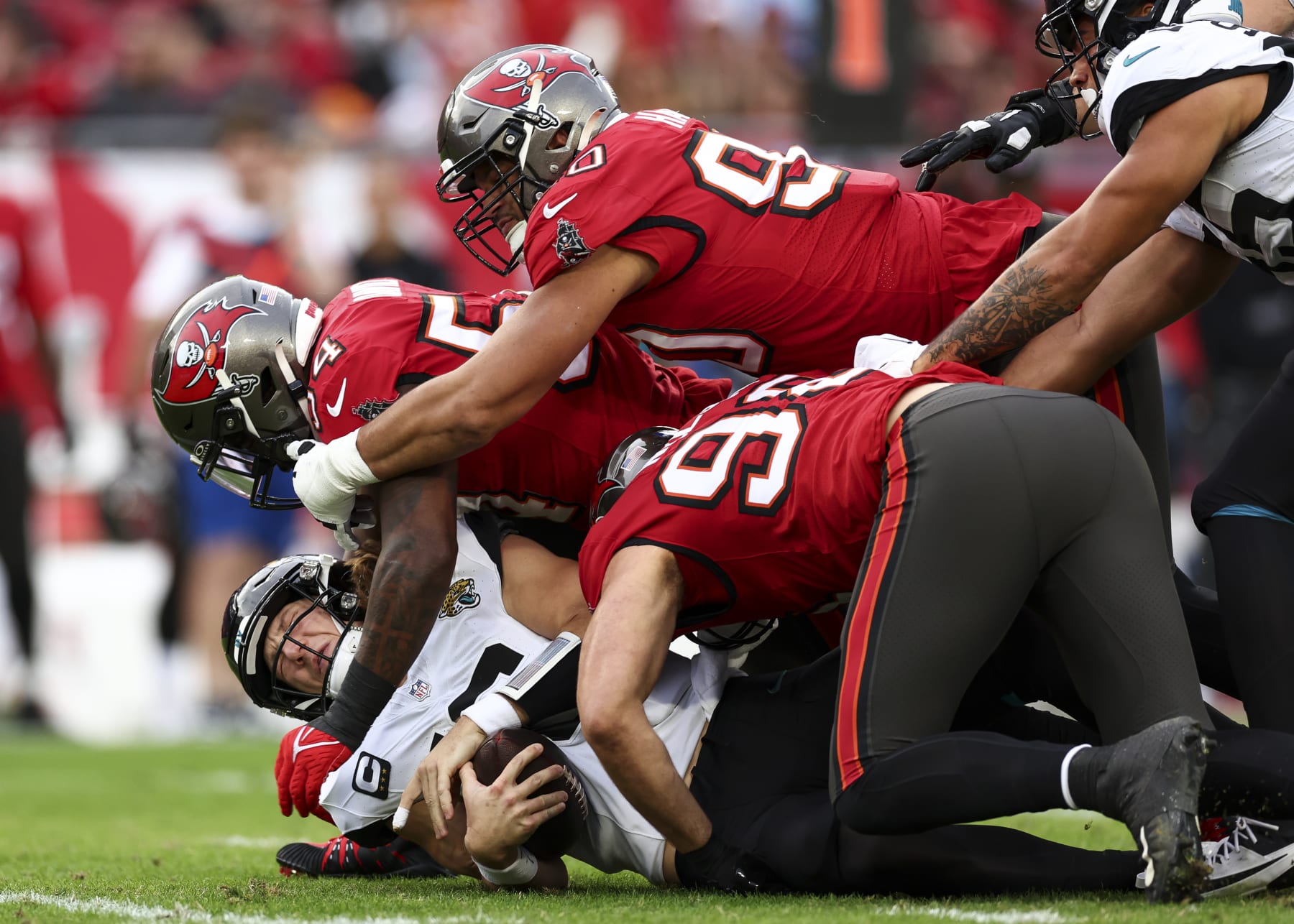 TAMPA, FL - DECEMBER 24: Lavonte David #54 of the Tampa Bay Buccaneers sacks Trevor Lawrence #16 of the Jacksonville Jaguars during the second quarter of an NFL football game at Raymond James Stadium on December 24, 2023 in Tampa, Florida. (Photo by Kevin Sabitus/Getty Images)