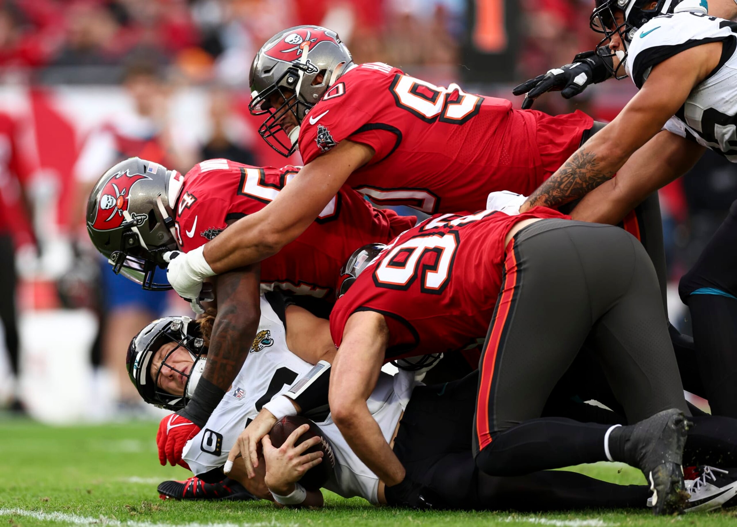 TAMPA, FL - DECEMBER 24: Lavonte David #54 of the Tampa Bay Buccaneers sacks Trevor Lawrence #16 of the Jacksonville Jaguars during the second quarter of an NFL football game at Raymond James Stadium on December 24, 2023 in Tampa, Florida. (Photo by Kevin Sabitus/Getty Images)