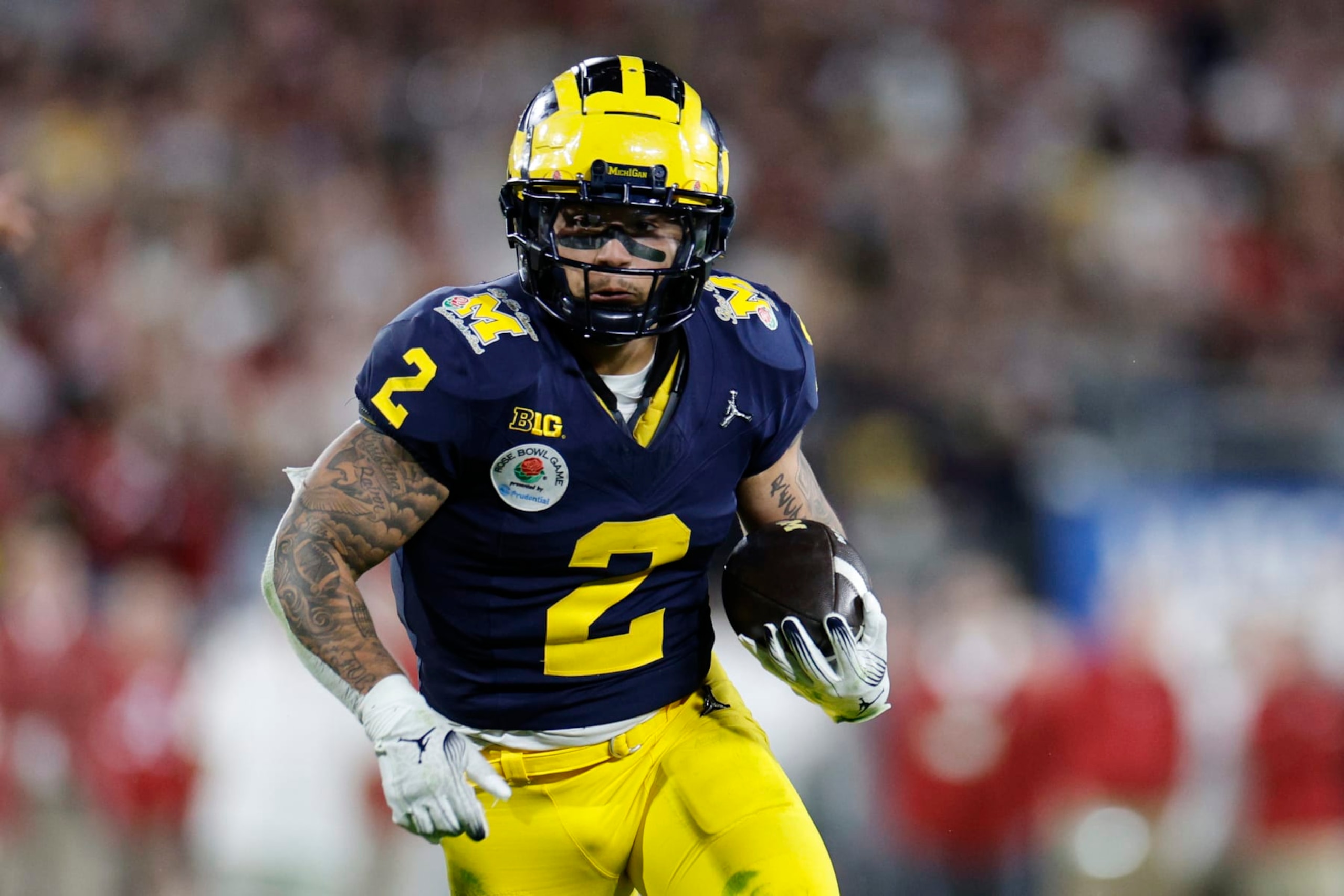 PASADENA, CALIFORNIA - JANUARY 01: Blake Corum #2 of the Michigan Wolverines runs with the ball in overtime against the Alabama Crimson Tide during the CFP Semifinal Rose Bowl Game at Rose Bowl Stadium on January 01, 2024 in Pasadena, California. (Photo by Kevork Djansezian/Getty Images)