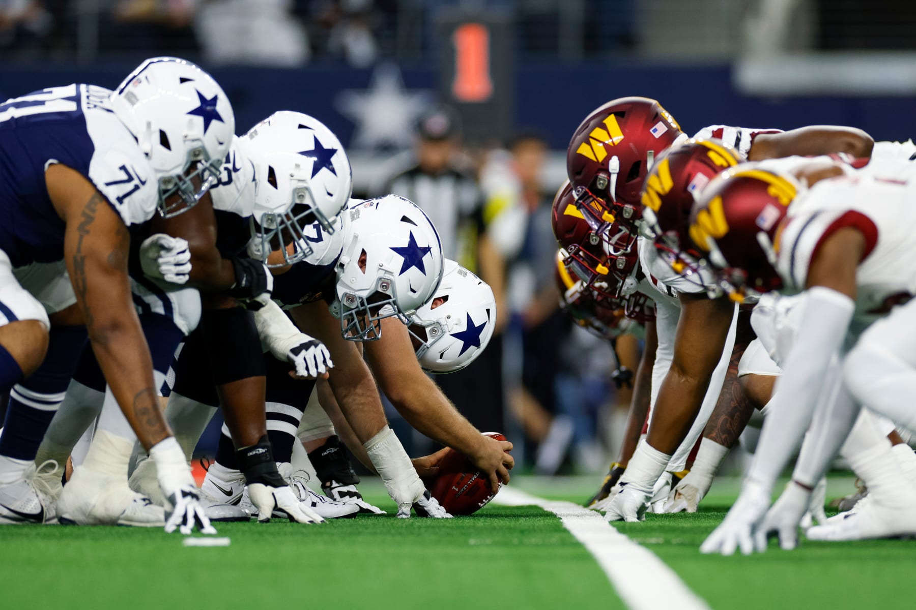 ARLINGTON, TEXAS - NOVEMBER 23: The Dallas Cowboys offensive line lines up across the Washington Commanders defensive line at the line of scrimmage during the first half at AT&T Stadium on November 23, 2023 in Arlington, Texas. (Photo by Brandon Sloter/Image Of Sport/Getty Images)