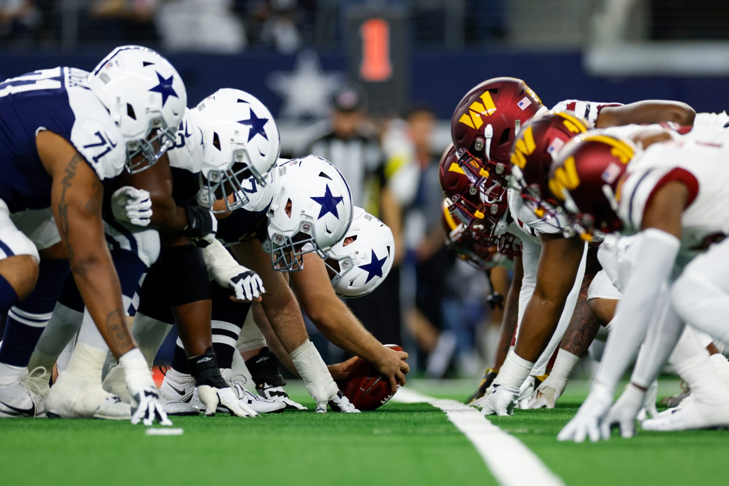 ARLINGTON, TEXAS - NOVEMBER 23: The Dallas Cowboys offensive line lines up across the Washington Commanders defensive line at the line of scrimmage during the first half at AT&T Stadium on November 23, 2023 in Arlington, Texas. (Photo by Brandon Sloter/Image Of Sport/Getty Images)