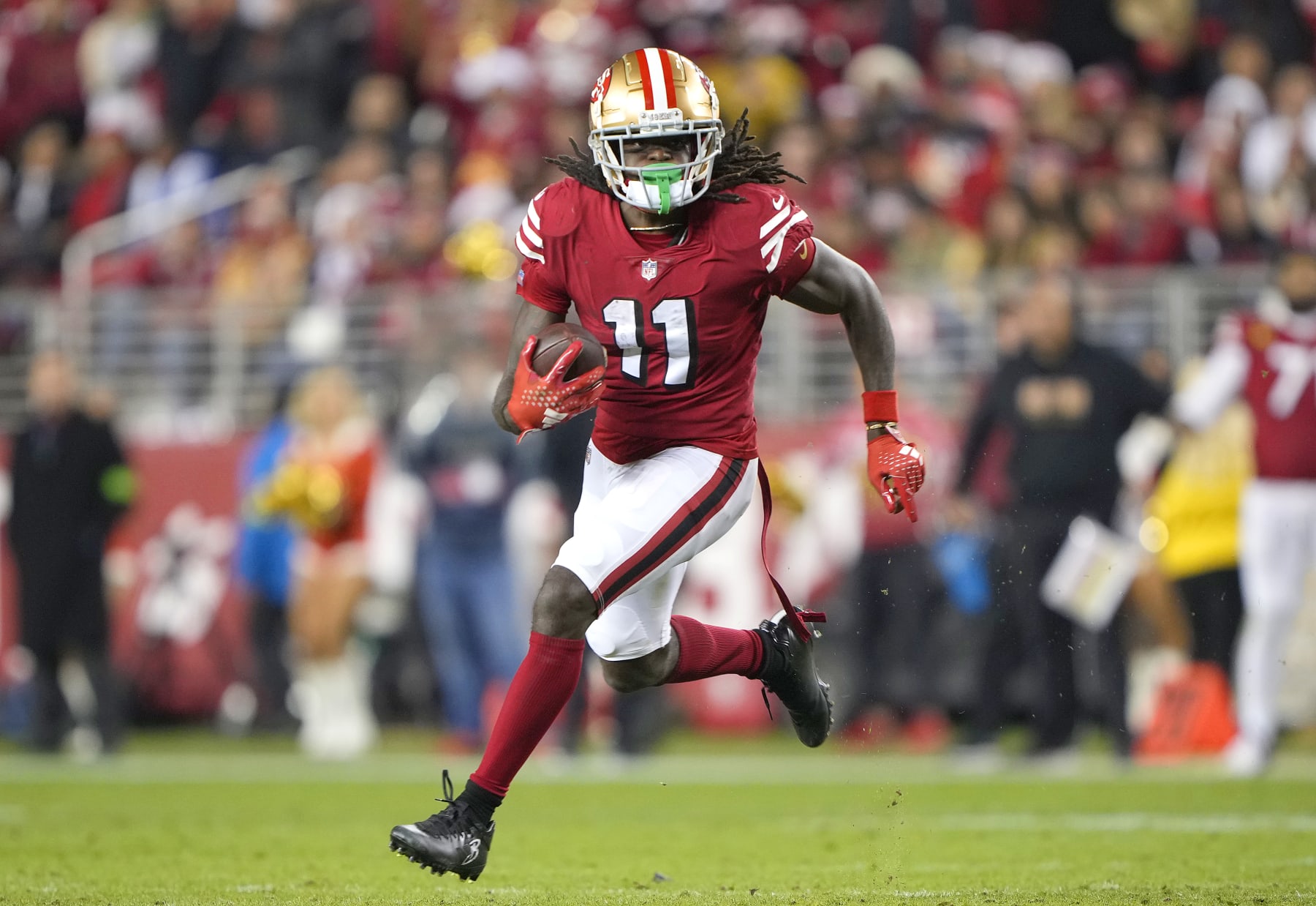 SANTA CLARA, CALIFORNIA - DECEMBER 25: Brandon Aiyuk #11 of the San Francisco 49ers runs with the ball after catching a pass against the Baltimore Ravens during the fourth quarter of an NFL football game at Levi's Stadium on December 25, 2023 in Santa Clara, California. (Photo by Thearon W. Henderson/Getty Images)