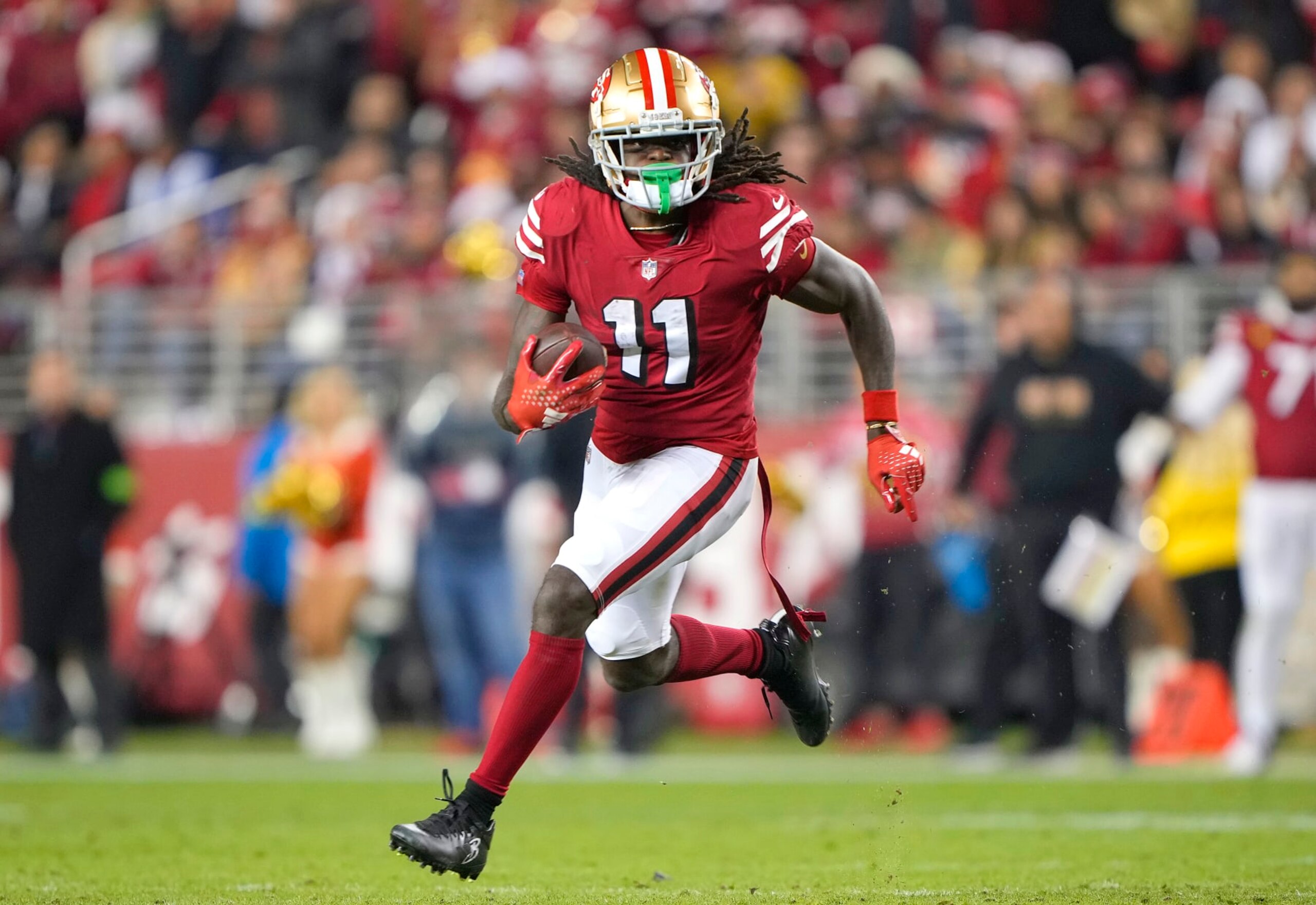 SANTA CLARA, CALIFORNIA - DECEMBER 25: Brandon Aiyuk #11 of the San Francisco 49ers runs with the ball after catching a pass against the Baltimore Ravens during the fourth quarter of an NFL football game at Levi's Stadium on December 25, 2023 in Santa Clara, California. (Photo by Thearon W. Henderson/Getty Images)