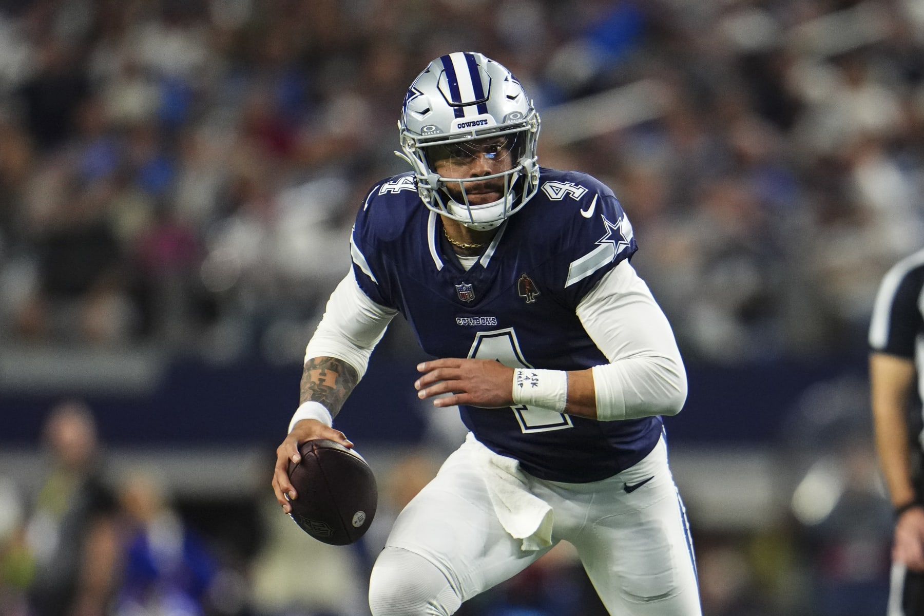ARLINGTON, TX - DECEMBER 30: Dak Prescott #4 of the Dallas Cowboys scrambles out of the pocket during an NFL football game against the Detroit Lions at AT&T Stadium on December 30, 2023 in Arlington, Texas. (Photo by Cooper Neill/Getty Images)