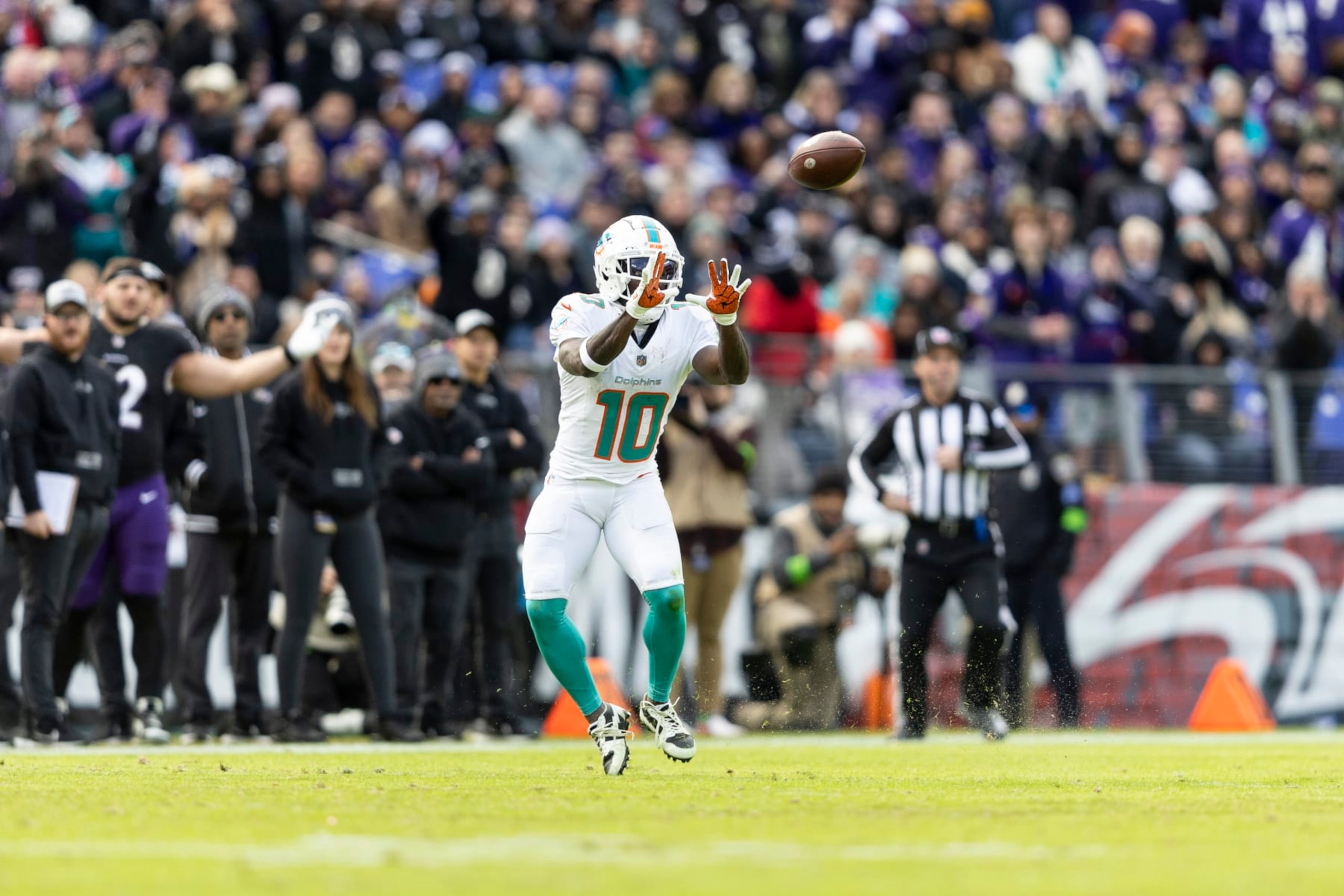 BALTIMORE, MARYLAND - DECEMBER 31: Tyreek Hill #10 of the Miami Dolphins completes a pass during an NFL football game between the Baltimore Ravens and the Miami Dolphins at M&T Bank Stadium on December 31, 2023 in Baltimore, Maryland. (Photo by Michael Owens/Getty Images)