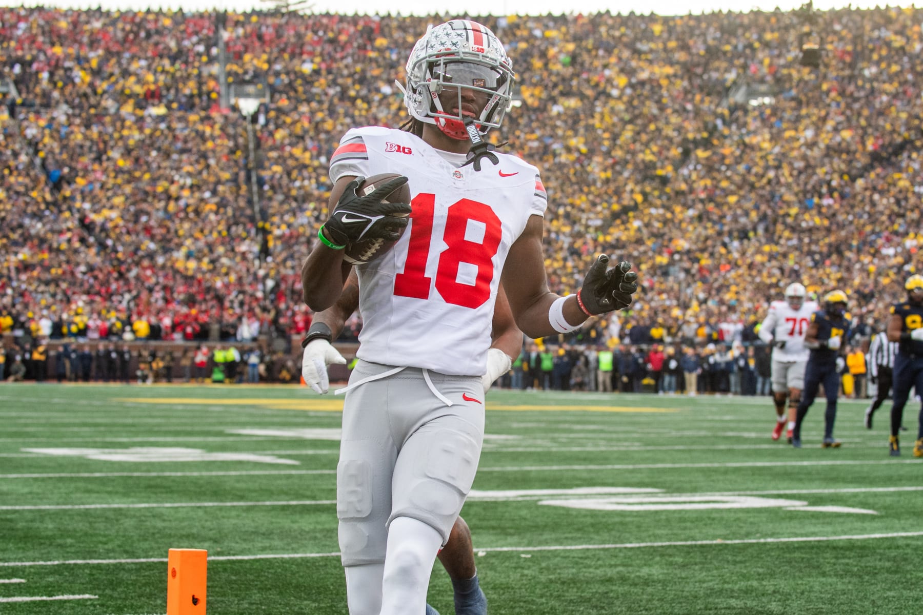 ANN ARBOR, MICHIGAN - NOVEMBER 25: Marvin Harrison Jr. #18 of the Ohio State Buckeyes runs with the ball for a touchdown during the second half of a college football game against the Michigan Wolverines at Michigan Stadium on November 25, 2023 in Ann Arbor, Michigan. The Michigan Wolverines won the game 30-24 to win the Big Ten East. (Photo by Aaron J. Thornton/Getty Images)