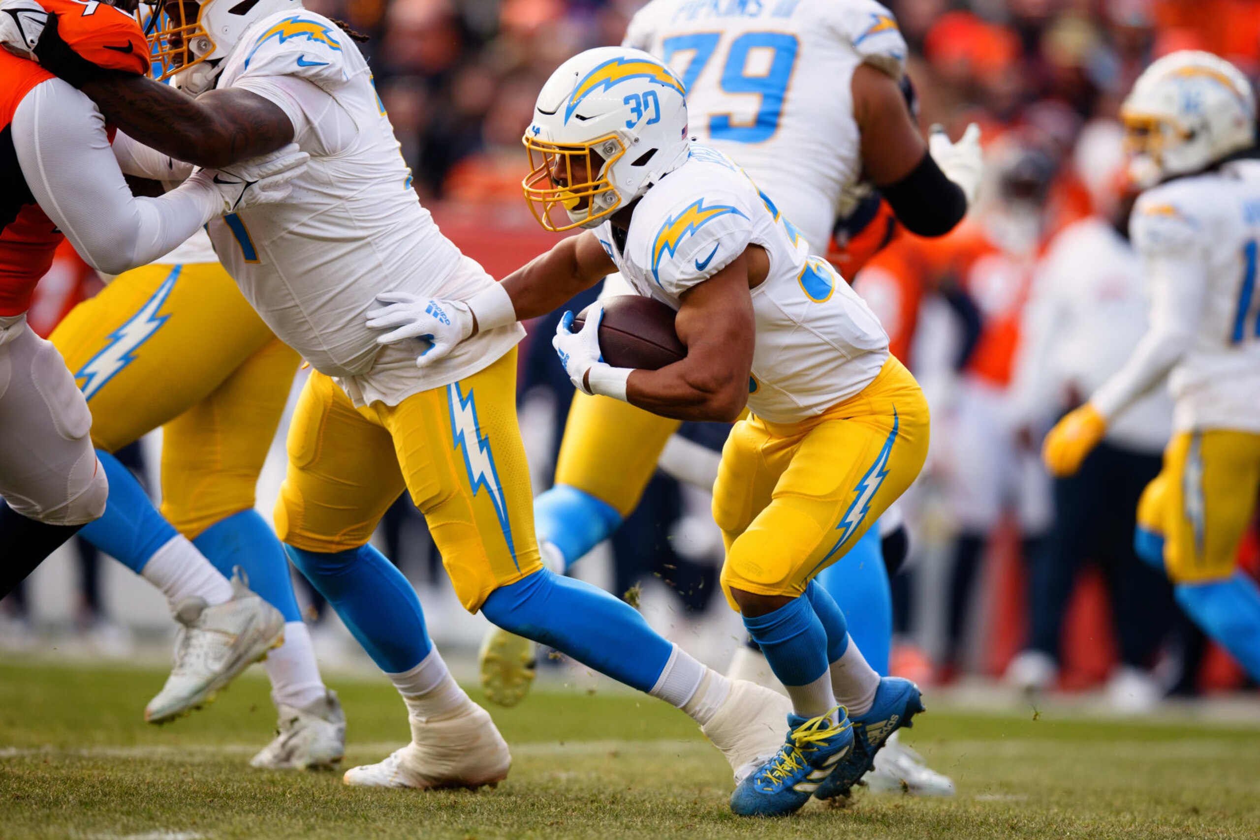 DENVER, CO - DECEMBER 31:  Running back Austin Ekeler #30 of the Los Angeles Chargers runs with the football during the first quarter against the Denver Broncos at Empower Field at Mile High on December 31, 2023 in Denver, Colorado. (Photo by Justin Edmonds/Getty Images)