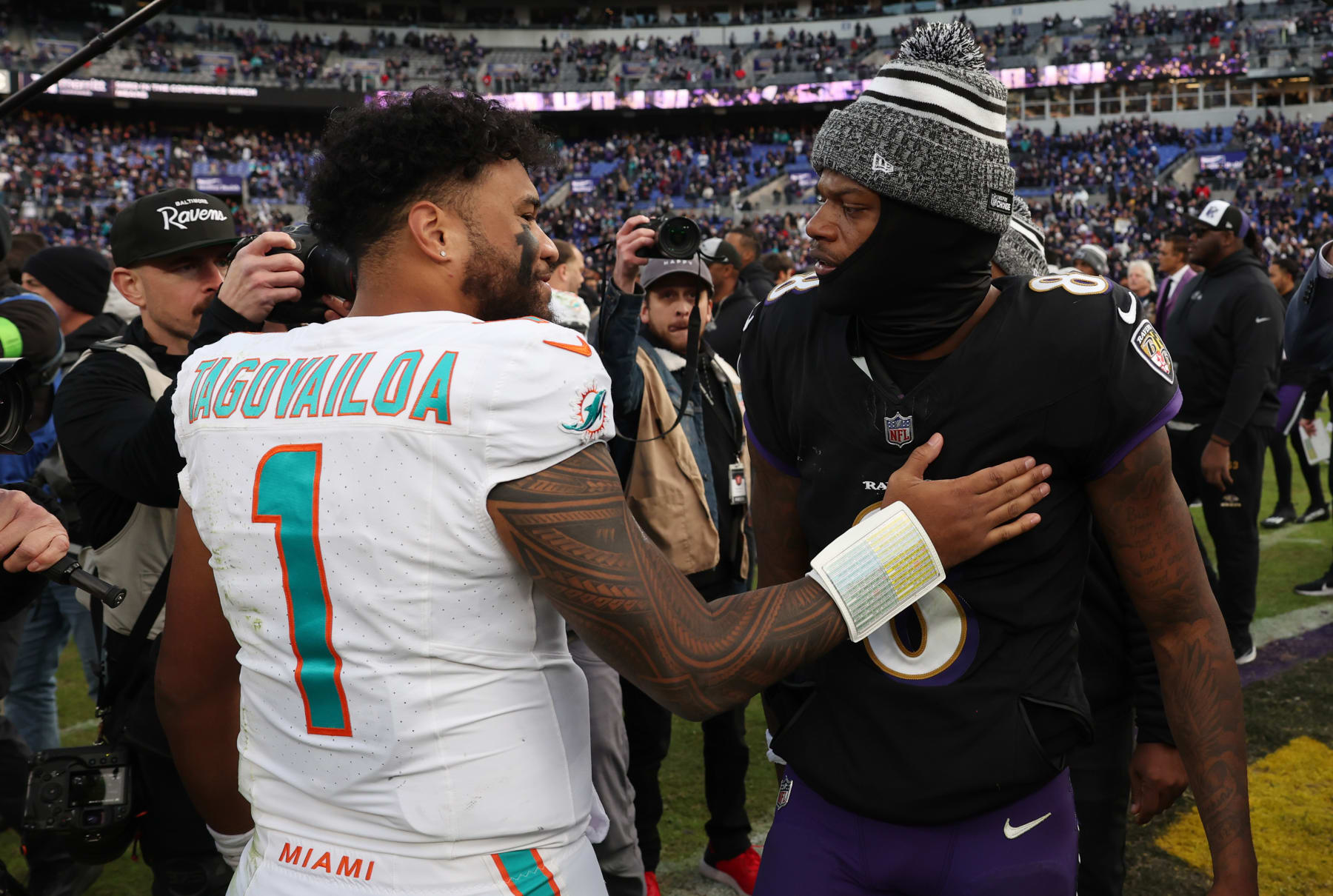 BALTIMORE, MARYLAND - DECEMBER 31: Tua Tagovailoa #1 of the Miami Dolphins and Lamar Jackson #8 of the Baltimore Ravens embrace on the field after their game at M&T Bank Stadium on December 31, 2023 in Baltimore, Maryland. (Photo by Todd Olszewski/Getty Images)