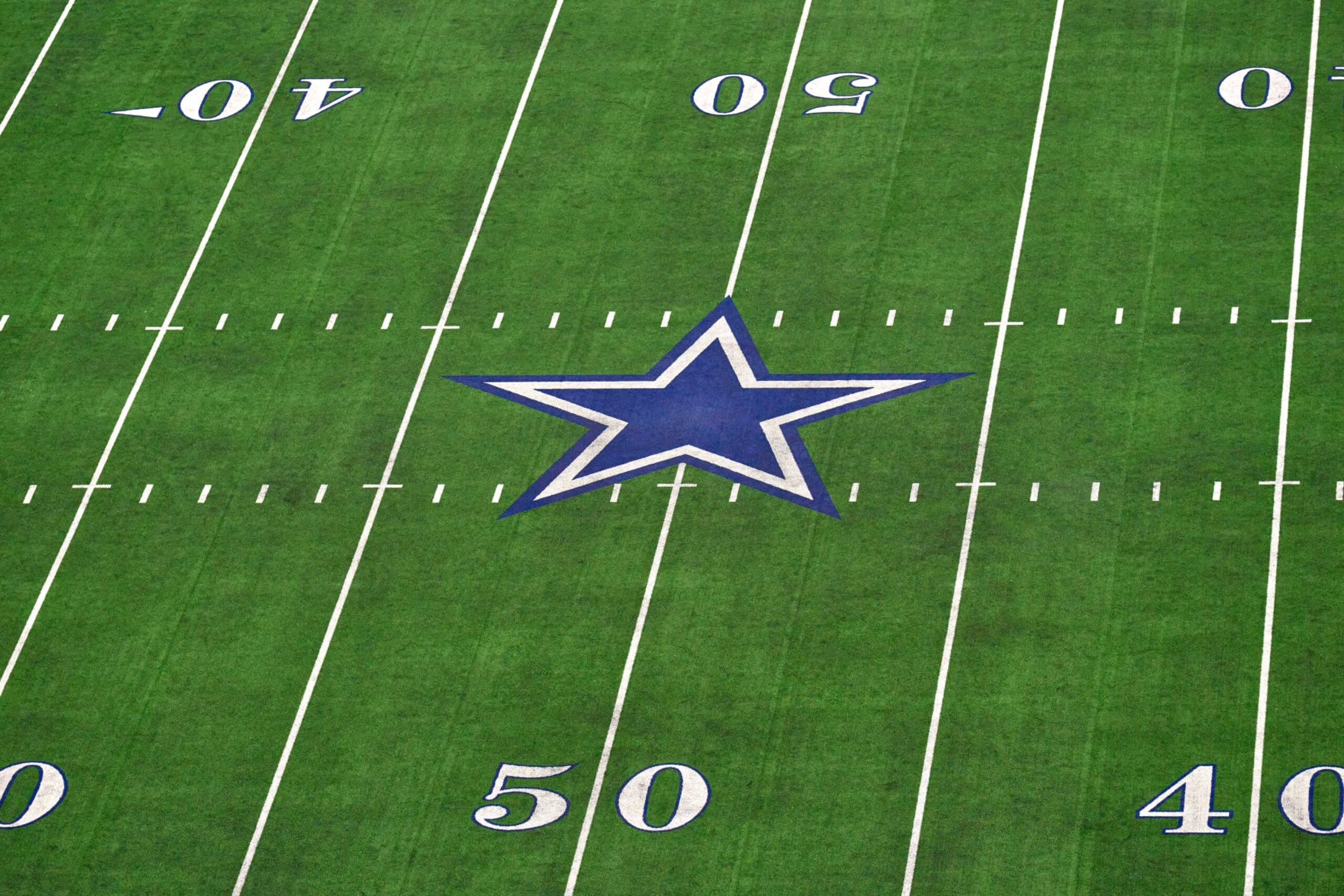 ARLINGTON, TX - JANUARY 16: A detail view of the Dallas Cowboys logo is seen at the center of the field during the NFC Wild Card game between the San Francisco 49ers and the Dallas Cowboys on January 16, 2022 at AT&T Stadium in Arlington, TX. (Photo by Robin Alam/Icon Sportswire via Getty Images)