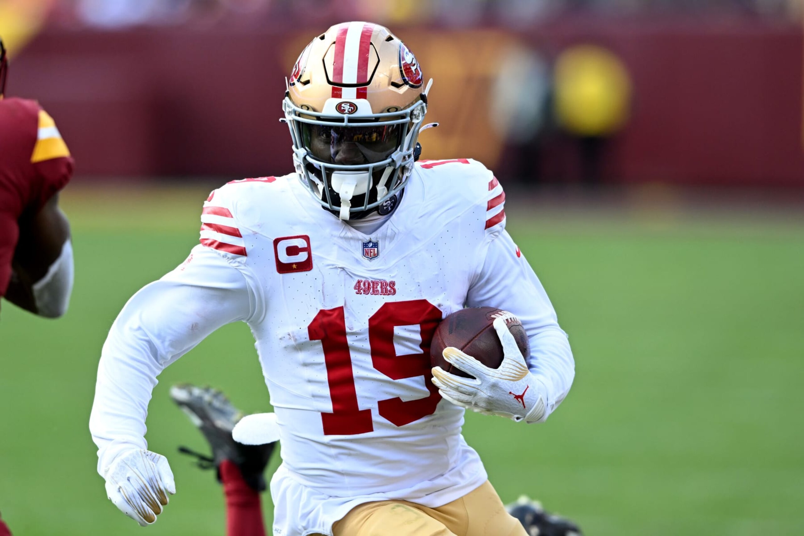 LANDOVER, MARYLAND - DECEMBER 31: Deebo Samuel #19 of the San Francisco 49ers runs with the ball during the fourth quarter of a game against the Washington Commanders at FedExField on December 31, 2023 in Landover, Maryland. (Photo by Greg Fiume/Getty Images)