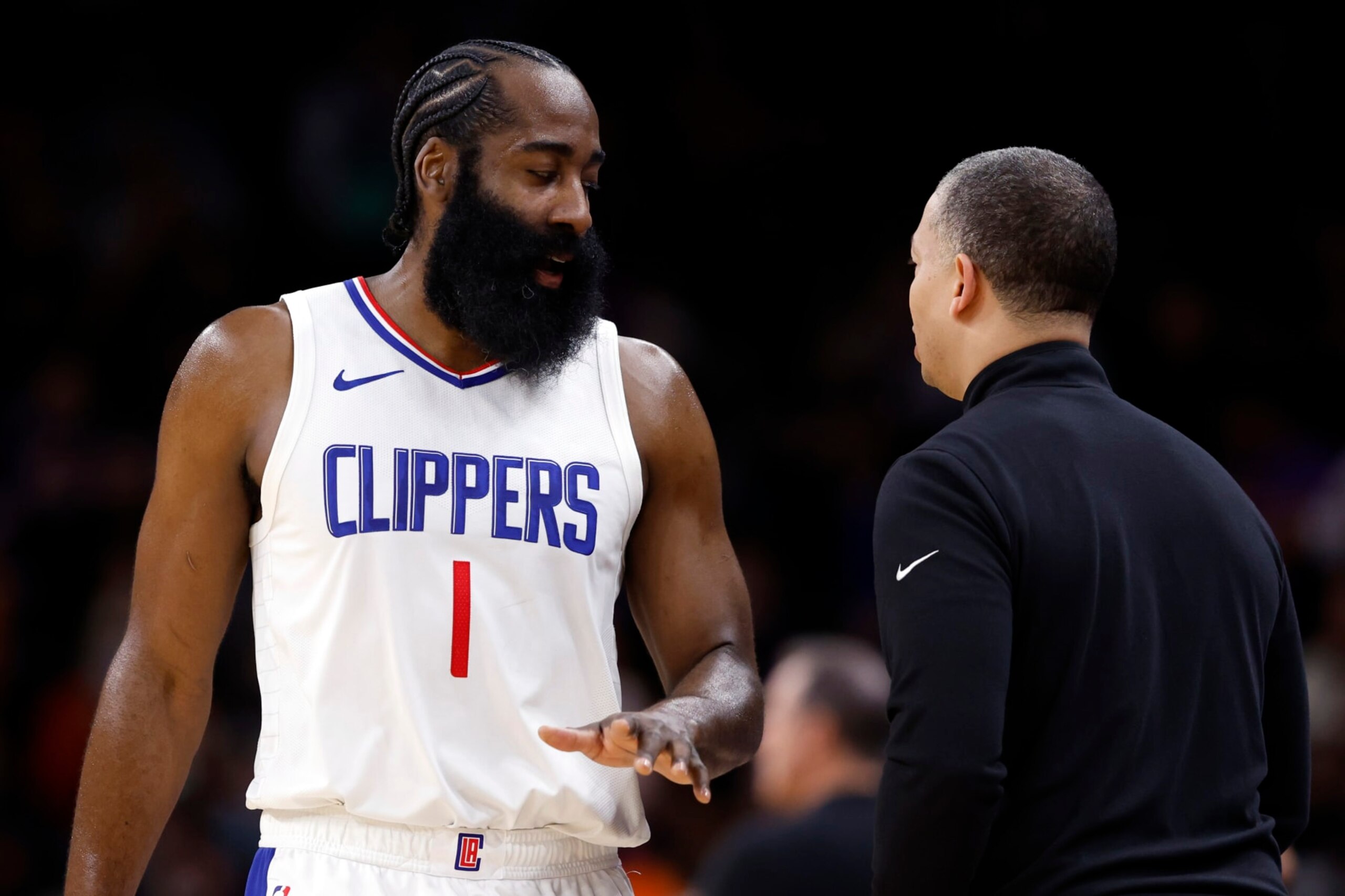 PHOENIX, ARIZONA - JANUARY 03: James Harden #1 of the Los Angeles Clippers talks with head coach Tyronn Lue during the first half against the Phoenix Suns at Footprint Center on January 03, 2024 in Phoenix, Arizona. NOTE TO USER: User expressly acknowledges and agrees that, by downloading and or using this photograph, User is consenting to the terms and conditions of the Getty Images License Agreement.  (Photo by Chris Coduto/Getty Images)