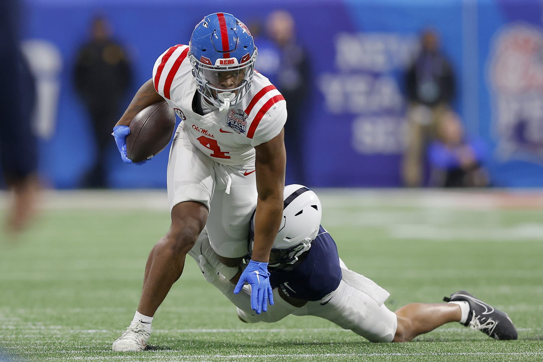 ATLANTA, GEORGIA - DECEMBER 30: Quinshon Judkins #4 of the Mississippi Rebels is tackled by Zakee Wheatley #6 of the Penn State Nittany Lions during the third quarter in the Chick-fil-A Peach Bowl at Mercedes-Benz Stadium on December 30, 2023 in Atlanta, Georgia. (Photo by Todd Kirkland/Getty Images)