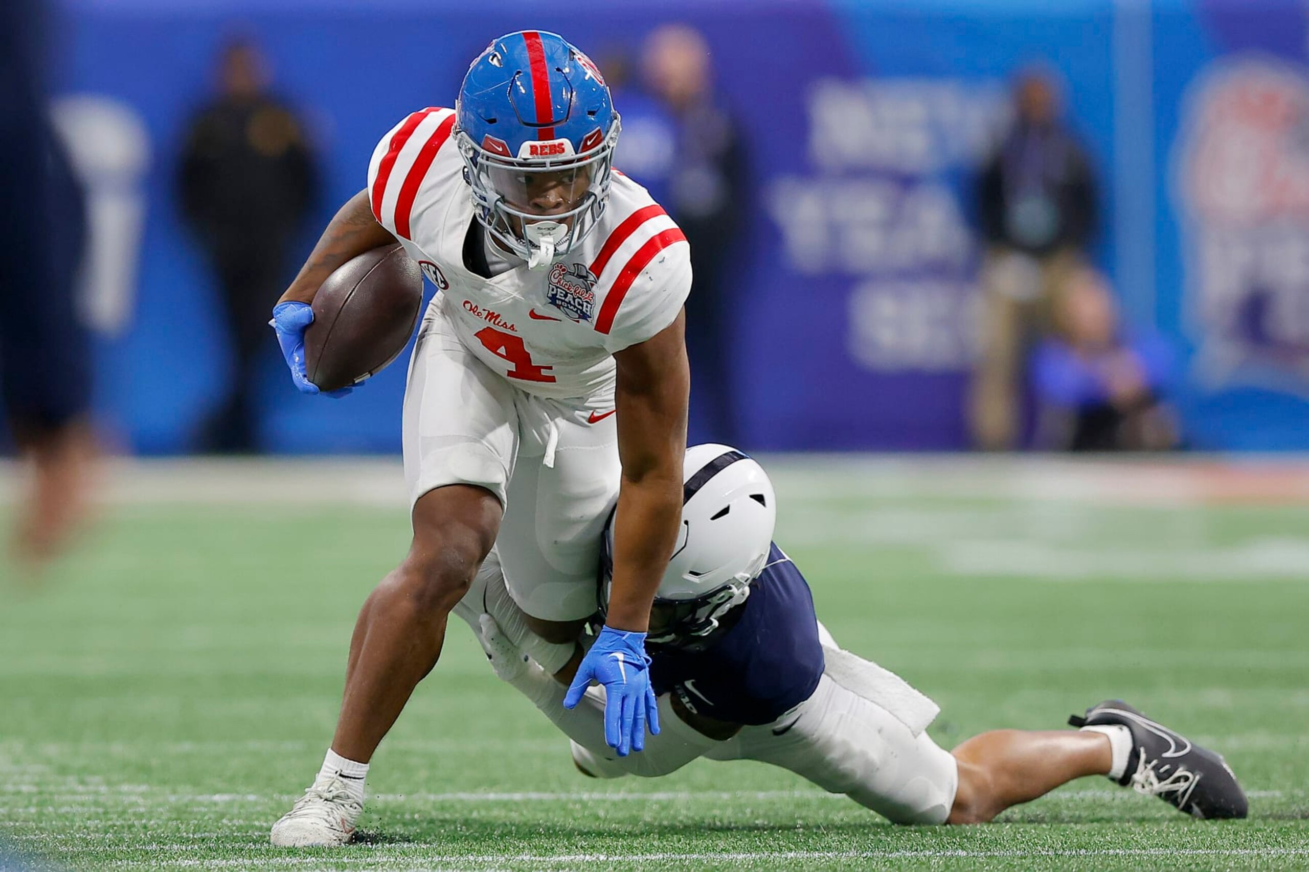 ATLANTA, GEORGIA - DECEMBER 30: Quinshon Judkins #4 of the Mississippi Rebels is tackled by Zakee Wheatley #6 of the Penn State Nittany Lions during the third quarter in the Chick-fil-A Peach Bowl at Mercedes-Benz Stadium on December 30, 2023 in Atlanta, Georgia. (Photo by Todd Kirkland/Getty Images)