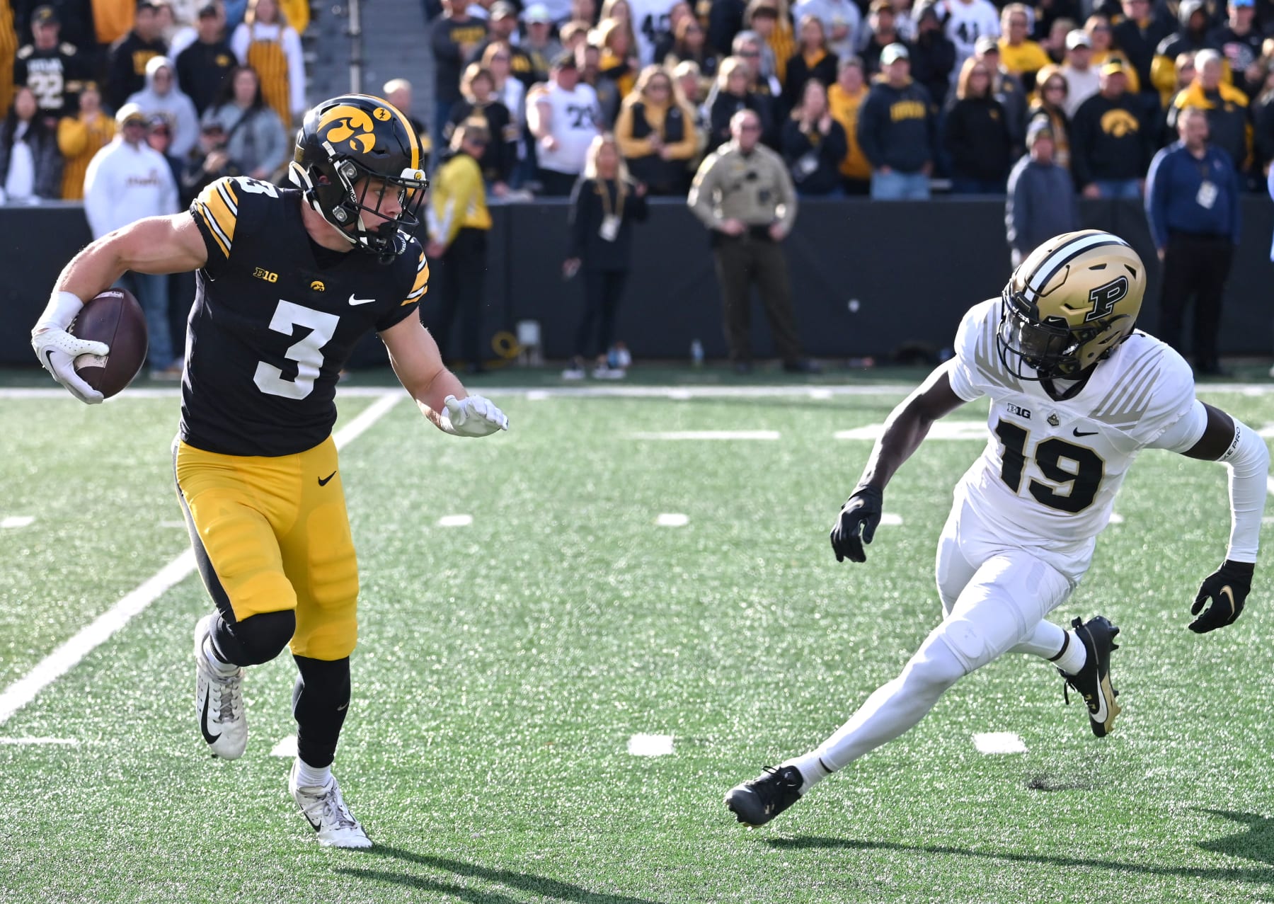IOWA CITY, IA - OCTOBER 07: Iowa Hawkeyes left corner back Cooper DeJean (3) runs back a uni as Purdue defensive back Botros Alisandro (19) defends during a college football game between the Purdue Boilermakers and the Iowa Hawkeyes on October 07, 2023, at Kinnick Stadium in Iowa City, Ia. (Photo by Keith Gillett/Icon Sportswire via Getty Images) IOWA CITY, IA - OCTOBER 07: Iowa Hawkeyes left corner back Cooper DeJean (3) runs back a uni as Purdue defensive back Botros Alisandro (19) defends during a college football game between the Purdue Boilermakers and the Iowa Hawkeyes on October 07, 2023, at Kinnick Stadium in Iowa City, Ia. (Photo by Keith Gillett/Icon Sportswire via Getty Images)