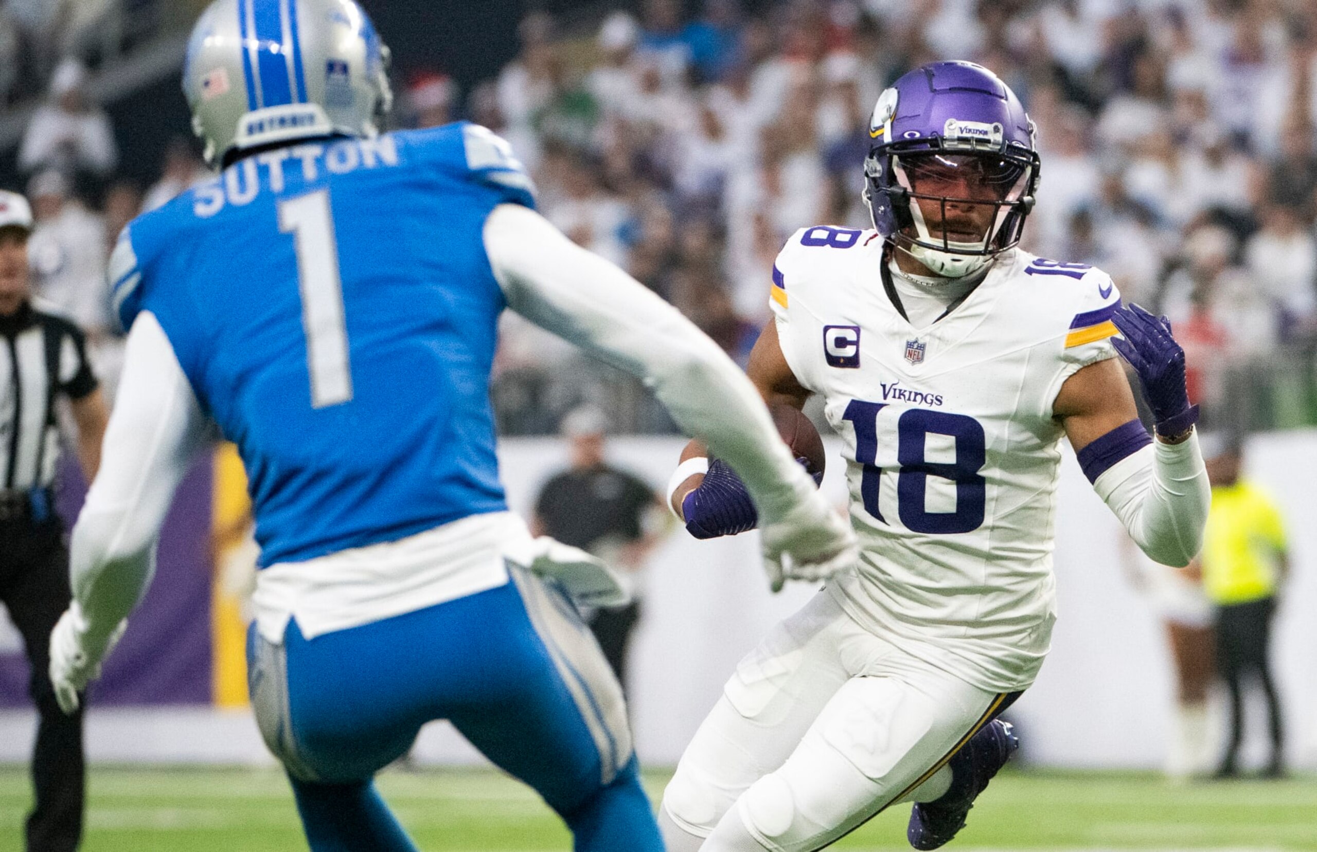 MINNEAPOLIS, MINNESOTA - DECEMBER 24: Justin Jefferson #18 of the Minnesota Vikings runs with the ball after a reception in the first quarter of the game against the Detroit Lions at U.S. Bank Stadium on December 24, 2023 in Minneapolis, Minnesota. (Photo by Stephen Maturen/Getty Images)