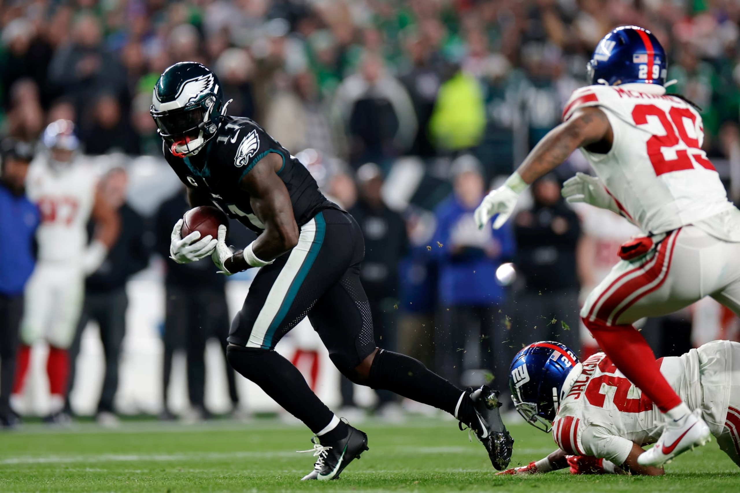 PHILADELPHIA, PENNSYLVANIA - DECEMBER 25: A.J. Brown #11 of the Philadelphia Eagles runs the ball against Adoree' Jackson #22 and Xavier McKinney #29 of the New York Giants during the fourth quarter at Lincoln Financial Field on December 25, 2023 in Philadelphia, Pennsylvania. (Photo by Adam Hunger/Getty Images)
